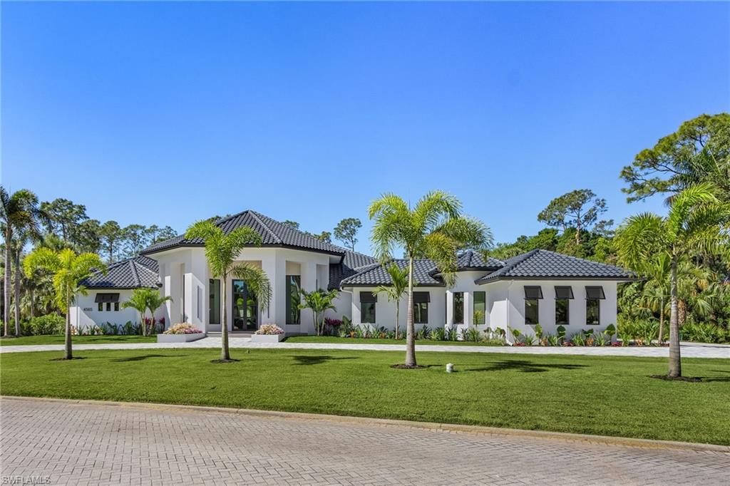 This exceptional residence has undergone a 18+ month transformation, elevating it to the pinnacle of modern luxury. This home has an ultra rare detached 2 bedroom, 1 bath casita / guest house with kitchenette which can double as a media room, gym, etc. Located in the heart of the prestigious Quail West Country Club, which boasts 2 championship level golf courses (immediate golf memberships are available), multiple tennis and pickleball courts, fitness center, salon, 2 restaurants, wine bar, and a cafe. Every facet of this home has been meticulously reimagined, from the soaring ceilings and expansive impact resistant doors and windows that flood the interiors with natural light, to the chef's kitchen with Taj Mahal Quartzite and Fisher & Paykel appliances. The master suite offers a serene retreat, with an oversized closet with secondary washer/dryer space. Outside, a private oasis awaits, showcasing a resort-style pool and outdoor kitchen overlooking a 100 acre protected preserve, perfect for entertaining or quiet relaxation. This home has an underground 1,000 gallon propane tank to power the whole home generator and kitchen range. County water supplies the home, while landscaping irrigation is provided by an onsite well pump. This home represents the epitome of refined living in one of the most exclusive neighborhoods in Naples, FL.