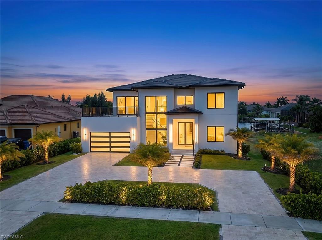Welcome to one of Cape Coral’s most impressive newly constructed waterfront estates. Completed in 2026, this custom-designed two-story luxury residence showcases exceptional craftsmanship, breathtaking Gulf-access lake views, and quick boating access to Charlotte Harbor, placing world-class fishing, waterfront dining, and the Gulf of Mexico within easy reach.

Perfectly positioned on an oversized Gulf-access homesite, this extraordinary estate features 6 bedrooms plus a den, 6.5 bathrooms, and a thoughtfully designed floor plan that blends luxury, comfort, and functionality. Expansive water views provide a stunning backdrop throughout, while contemporary architecture and meticulous attention to detail create a lasting first impression.

Designed for everyday living and grand-scale entertaining, the resort-style outdoor living area rivals the finest luxury resorts. Enjoy spectacular sunsets from the infinity-edge saltwater pool with spa, sun shelf, bubblers, and panoramic waterfront views. The spacious covered lanai features a full outdoor kitchen with gas grill and refrigerator, pool bath, limestone pavers, professional landscaping, and a screened enclosure.

Inside, soaring ceilings, dramatic walls of glass, and expansive sliding doors flood the home with natural light while seamlessly connecting indoor and outdoor living. The open-concept great room is anchored by a chef’s kitchen featuring premium Thermador appliances, including a gas cooktop, double wall ovens, panel-ready refrigerator, dishwasher, built-in microwave, custom cabinetry, Taj Mahal quartzite countertops, designer lighting, a full-height wine display, walk-in pantry, and spacious laundry room.

Architectural highlights include a floating staircase with solid wood treads and glass railings, European-style interior doors, custom closets, Hansgrohe fixtures, smart toilets, and designer finishes throughout. The first-floor primary suite offers a spa-inspired bath with soaking tub, oversized walk-in shower, dual vanities, premium fixtures, bidet, and tranquil water views.

The generous bedroom count and flexible floor plan are ideal for multigenerational living, large families, executive retreats, or luxury vacation rentals. Guest suites and versatile living spaces provide privacy and comfort for family and visitors alike.

Additional features include an epoxied garage floor, circular driveway, modern coastal architecture, and exceptional curb appeal. Whether you're searching for a private luxury residence or premier investment opportunity, this newly completed waterfront estate delivers an unmatched combination of size, design, location, and boating lifestyle.

Enjoy quick boat access to Charlotte Harbor, Southwest Florida’s best fishing, barrier islands, waterfront restaurants, and pristine Gulf beaches. Opportunities to own a brand-new Gulf-access lakefront estate of this caliber are exceptionally rare.