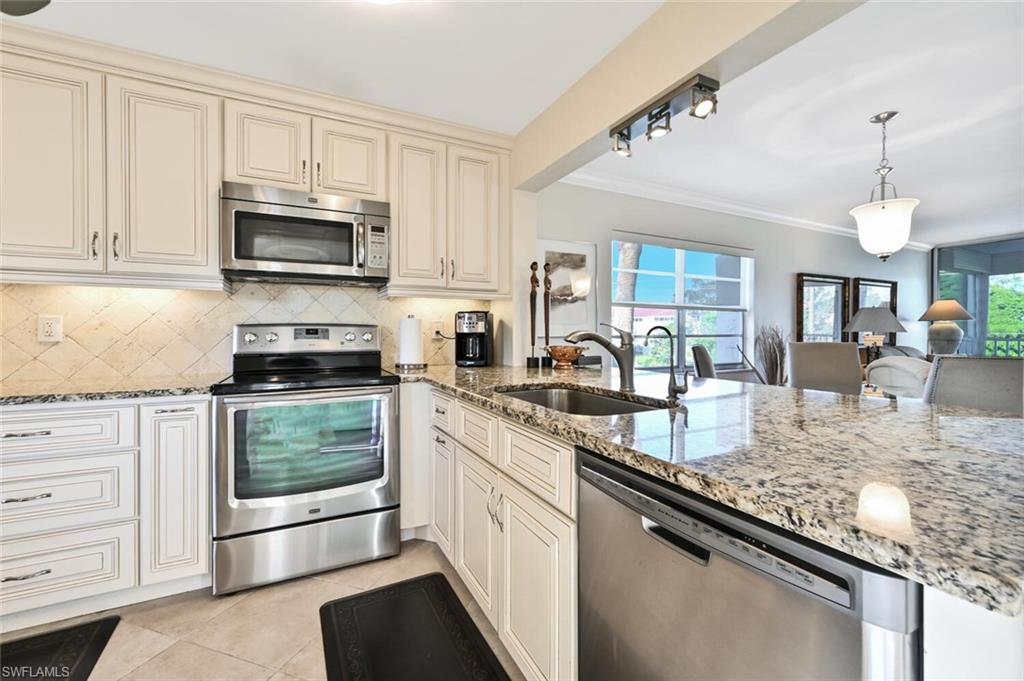 Simply the best and rarely for sale! Elegant, top floor, corner end unit with 180 degree views of Quail Run golf course and lake (golf membership not required) in a 55+ community, offered turnkey. Approx. 1 mile to the beach. Beautiful 18" diagonal tile floors throughout. Large custom designer kitchen with soft close drawers, 4 pot drawers & slide out oil/vinegar storage pullout. Stainless steel appliances & granite countertops with more than ample workspace. Spacious 14.6’ wide living room with crown molding & 6” baseboards. Oversized eating area with golf course views from all windows. Hallway with butler’s pantry/bar, perfect for entertaining. Generous master - Ensuite with frameless glass 6' walk-in tiled shower, Maple vanity, Granite top and walk in closet. Roomy, light and bright guest room, great to use as an office too. Guest bath with tub /shower combo, maple vanity with granite top. Screened lanai with fabulous views and extra storage closet. Features include: Smooth ceilings, Fans in every room, Kitchen pantry,  Extra storage locker, Newer AC, Assigned covered parking, Elevator, 3 pools, 2 clay tennis courts, Shuffleboard. Close to shopping and restaurants.