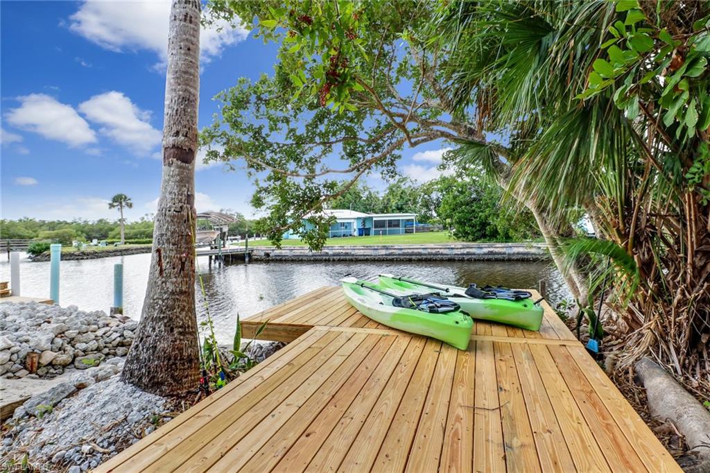 Over-sized 10,074 sq ft. lot and 75+ ft right on the water! Newer roof. Prime location and excellent property for investor or owner. Sunset views right from the home. Open floor plan. Very light and bright! New flooring. New kitchen cabinets, new hot water heater, new washer and dryer, new appliances, new base boards and trim work, new paint, new decks in front and back of home, updated electrical. Large storage area under the home. There is a great boat ramp located right on the property as well ! Very quiet street. Quick ride into Estero Bay and then into the GULF OF MEXICO! NO HOA FEES! NO SPECIAL ASSESSMENTS! NO RESTRICTIONS! WOW! Enjoy Lovers Key State Park and New Pass everyday! You can build up to 35' high. Minutes to Coconut Point and the Hyatt Resort. This is a perfect opportunity to finally build that DIRECT GULF ACCESS home you want! Drive by anytime and see this gem! Only a few minutes by boat and you are at New Pass as well as Bonita's Dog Beach!
