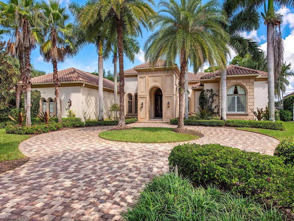 A stunning paver circle driveway leads to this lavish estate situated on an over-sized lot boasting panoramic lake & golf course views. Dramatic appointments include volume tray ceilings, wide crown moldings, extensive windows, arched passageways, majestic columns and gorgeous stone flooring throughout the main living areas. The gourmet kitchen features top of the line built in appliances, two refrigerators, raised panel wood cabinetry & gorgeous granite topping the work surfaces, center island & breakfast bar. Retreat to the master suite with picture windows, massage room and a relaxing sitting area in the spacious master bedroom with direct access to the intimate sunlit poolside patio. Exceptional outdoor covered & open-air living areas complete this incredible residence while automatic roll down screens allow this area to be used year-round. Majestic columns accent the loggia as you enter onto the fantastic pool deck surrounding the sparkling pool and spillover spa. Panoramic lake and golf course views are the perfect backdrop for this magnificent estate that strikes a unique balance of elegance, luxury and comfort.