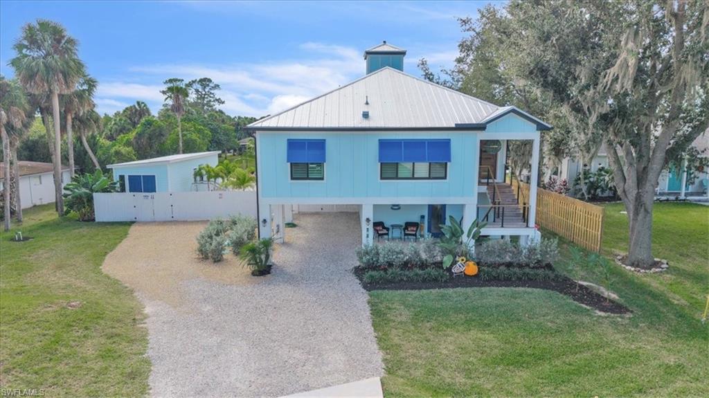 Waterfront living at its finest, must see to truly appreciate! Experience the ultimate Florida coastal lifestyle in this one-of-a-kind waterfront retreat offering three separate living spaces and exceptional income or multigenerational potential. Perfectly positioned along 100 feet of canal frontage, this property delivers a true private resort setting with direct water access from canal to Caloosahatchee River and an expansive sandy beach framed by swaying palms, hammocks, and a custom fire pit. The main residence, located on the upper level, features 2 bedrooms and 2 full bathrooms with custom-milled wood flooring throughout. A chef’s kitchen anchors the home, complete with a 12-foot island, natural gas 48-inch range with dual ovens, wine cooler, and a walk-in pantry. Expansive sliding glass doors open from both the primary suite and main living areas to a large elevated deck, seamlessly blending indoor and outdoor living. The lower level of the main home includes a private 600-square-foot apartment or in-law suite with its own entrance, kitchenette, full bathroom, and covered porch—ideal for guests or rental use. A detached guest cottage offers a third independent living space, featuring an open-concept layout with kitchenette, private laundry, full bathroom, and its own porch set directly along the sand. Designed for entertaining, the outdoor living area showcases a resort-style pool with a swim-up bar, connected to a custom tiki hut, creating a true Florida-inspired gathering space. Whether utilized as a primary residence, vacation home, or income-producing property, this unique offering captures the essence of waterfront living with unmatched versatility and lifestyle appeal.