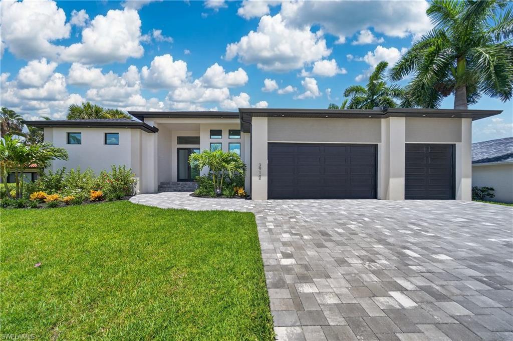 Brand New Modern Luxury in the upscale the Savona neighborhood surrounded by stunning waterfront homes. From the moment you arrive, this 2,369 sq ft modern masterpiece makes a statement. 10’8” dramatic tray ceilings, and a designer feature wall set the tone for the elevated finishes found throughout. The open-concept layout flows effortlessly from an island kitchen featuring built-in cooktop, wall ovens, and a oversized walk-in pantry with barn door entry. The highlight is what may be the finest outdoor living space in its class. The sun-drenched pool area is a showstopper. A resort-style pool with built-in spa and swim shelf, travertine pool deck, an expansive covered area with outdoor kitchen and bar — designed from the ground up for entertaining. Whether you’re hosting a crowd or unwinding after a long week, this backyard delivers the Southwest Florida lifestyle at its absolute best.
Inside, the spacious primary suite offers dual walk-in closets an elegant spa like bathroom while two additional bedrooms and three full baths including a pool bath, provide flexibility for family and guests. A large utility room and three-car garage with epoxy flooring round out the practicality. This is new construction luxury without the wait, without the compromises, and in the right neighborhood
