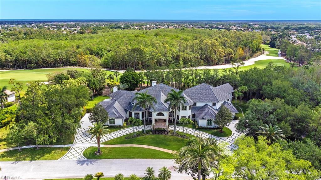 Magnificent completely renovated estate home in Quail West offering the ultimate in privacy and luxury living including immediate golf access with a transferrable golf membership included. Situated on a rare double lot that spans 2.2 acres, this residence offers golf course views and an incredible volume of living space with 11,160 SF including 6 bedrooms, 7.5 baths, office, study, exercise room, media room, bonus living room and 5 garage spaces plus a golf cart garage. Upon entering the home, the main living room is sure to impress with soaring 24’ ceilings, a curved stone staircase, a gas fireplace and zero-corner sliders that lead to the extraordinary outdoor area. Enjoy Naples’ glorious weather with 1,062 SF of covered outdoor living, a full bar with folding windows, a resort style pool with a waterslide, large spa and a gazebo centerpiece with an outdoor kitchen. Completely remastered in 2024, this home showcases the finest in custom craftsmanship and the latest technology, including wide plank oak flooring with decorative brass inlay, handcrafted custom rift-sawn white oak cabinetry, Andersen A-Series impact windows/doors, extensive moldings, exquisite light fixtures and a Control-4 smart home system. The spectacular chef's kitchen is centered around a large island with honed Mont Blanc quartzite countertops and beautifully combines rift-sawn oak, white and black custom cabinetry accented with brass fixtures and includes a Viking gas range with dual ovens, a Sub-Zero refrigerator, custom coffee bar and a full butler's pantry. Retreat to the sprawling primary suite with a spacious bedroom boasting a lofted 17’ ceiling, a secluded living area with a wet bar, an exercise room with a sauna and a brilliant custom closet. The elegant his-and-hers primary bathroom is adorned with natural stone and fine cabinetry, includes a steam room, a luxurious glass enclosed wet area with a vessel soaking tub and a double shower plus access to a private courtyard with a water feature, an outdoor shower and a cold plunge spa. The spectacular main office has dual oak and glass entry doors, built-in cabinetry and a custom ceiling that reaches over 27’. Also on the main level; a media room, 2 spacious guest suites, a formal dining room and a family room. The 2nd level of the home is constructed with solid concrete, accessible via stairs or elevator, offers high 11’ ceilings and features a second office plus 3 spacious bedrooms including a bunk room and large bonus living room with ceilings over 16’, a kitchenette and access to a large terrace. Quail West offers a captivating lifestyle in an exquisite community with 36-holes of pristine Arthur Hills-designed golf, a 100k SF clubhouse that’s the hub of social activities with multiple dining options, an indoor lagoon-style Junior Olympic-sized pool and a full-service spa. The sports center offers 8 clay hydro tennis, 4 pickleball, 4 bocce courts and a 2-story fitness/wellness building.