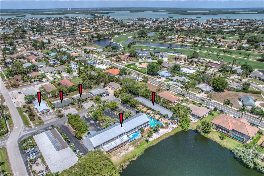 The Marco Island Lakeside Inn. Opportunity is knocking and you have 24 doors to answer. Hyper rare offering of 2 hotel buildings and 3 adjoining duplex homes, combined there are 24 units. The main building features 2-two bedroom/1 bath units and 8-1 bedroom/1 bath units. These 10 units were just totally remodeled and beautifully furnished. They have full kitchens and spectacular views of Marco Lake. The second adjacent hotel building features 7 studio/efficiency units and 1-2 bedroom/1 bath unit. The 3 duplex homes have 6 total 2-bedroom/1 bath units. The 8-unit hotel building and the 3 duplexes all suffered water intrusion from Hurricane Ian. All of those units have been gutted out to a degree, and all new A/C units have been installed. There are some new refrigerators, stoves, and microwaves being stored in the main building that are included in the sale. The main building used to be the home of Busghetti's Restaurant and that part of the building has been gutted. You could either put in a new restaurant or add a minimum of 2 additional hotel rooms.