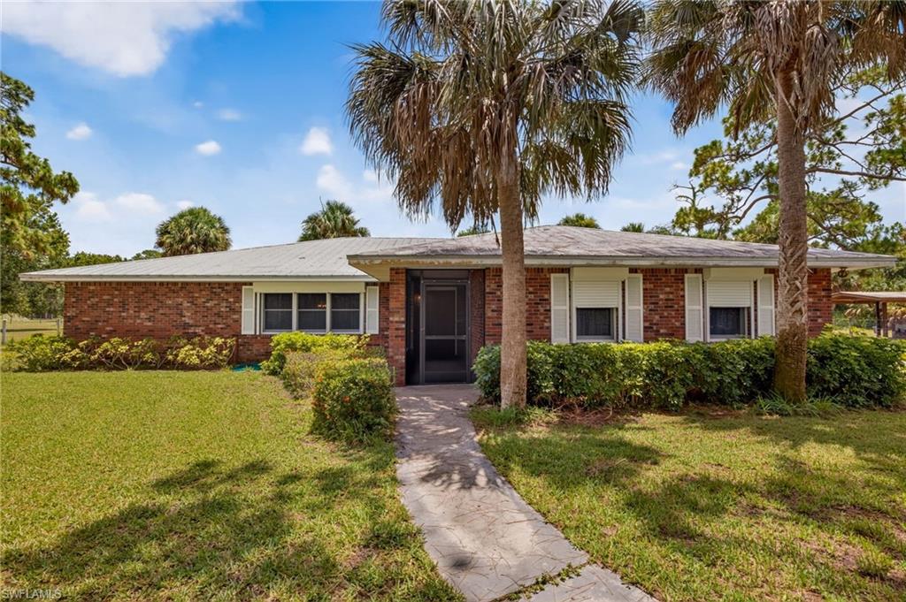 Discover the perfect blend of country living and modern convenience on this exceptional one-owner estate nestled on nearly 10 picturesque acres in Fort Myers. Zoned AG-2, this lovingly maintained property offers endless possibilities for horse enthusiasts, buyers looking for a working property, livestock owners, or anyone seeking privacy, space, and the freedom to enjoy a true rural lifestyle—all just minutes from shopping, dining, I-75, and Southwest Florida International Airport.

Built in 1980 and well maintained by its original owners for more than four decades, this cherished family property reflects a lifetime of pride in ownership and careful stewardship.  This 2,337-square-foot home features 4 bedrooms, 2 full bathrooms, multiple spacious living areas, a formal dining room, a cozy breakfast nook, and a welcoming family room centered around a beautiful brick fireplace. Large windows in the formal living room and bedrooms frame peaceful views of the surrounding acreage, while mature yellow pines and majestic oak trees create a tranquil Old Florida setting.

Step outside and discover everything this remarkable property has to offer. The property's covered outdoor kitchen or "Cook Shack" creates the ultimate outdoor gathering space. Complete with a metal roof, built-in charcoal grill with chimney, running water, electricity, and room to entertain, it's the perfect place for family fish fries, backyard barbecues, holiday celebrations, and making memories that will last a lifetime.

The impressive pole barn provides exceptional flexibility with an air-conditioned office, additional air-conditioned center room, workshop, half bathroom, laundry tubs, and electricity throughout—ideal for a home business, workshop, hobby space, or equipment storage.

Animal lovers will appreciate the fenced acreage, complete with hog wire fencing surrounding both the homesite and the property's interior perimeter. A separate, open-air dog kennel building, equipped with electricity and running water, offers endless possibilities for breeding, boarding, livestock, poultry, or other agricultural uses. A freshwater pond enhances the front of the property, while a separate storage shed provides additional space for tools and equipment.

Recent improvements include a new A/C compressor (March 2026), brand-new septic sump pump and aerator, allowing the next owner to enjoy peace of mind.

Whether you envision a private family estate, a working farm, equestrian property, or simply a peaceful retreat surrounded by nature, this exceptional property offers endless possibilities. Properties like this rarely become available—offering nearly 10 fenced acres, AG-2 zoning, mature trees, extensive outbuildings, and the opportunity to create your own private country retreat in the heart of Fort Myers.