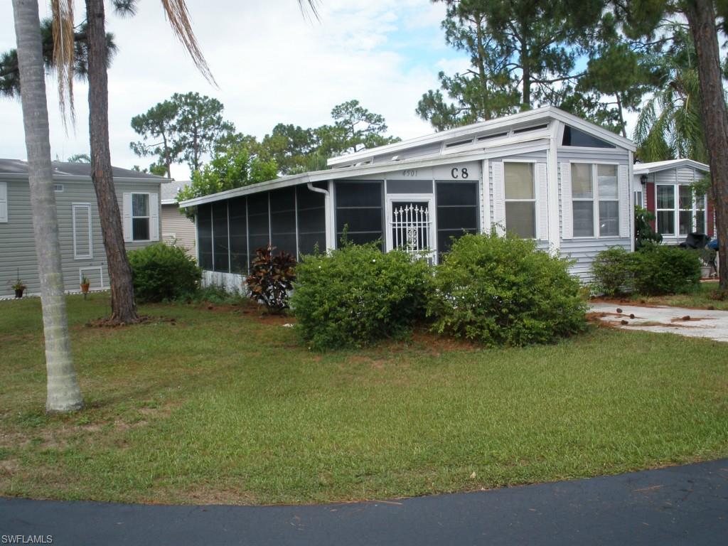 Holiday House Park model with Eastern exposure Florida room.  Beautiful corner lot within close proximity to the recreational area and pool.