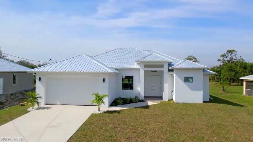 Gorgeous 3 Bedroom plus den/office in a well-established neighborhood in Lehigh Acres. Great location and close proximity to all major shopping, schools and attractions. Top quality and design home with plenty of upgrades. Hight interior ceiling with 9'4" in bedrooms, 11'0" in living room area and 12'0" tray ceiling. Porcelain tile throughout the house and exterior tile Anti slip in porch and lanai. The kitchen countertop is quartz sparkling white. Modern cabinets shaker style with 36" high on the top and soft close doors. Wood closet interior design in master bedroom closets. Beautiful top brand stainless-steel appliances. Washer & Dryer included. The house has HURRICANE IMPACT WINDOWS AND SLIDING DOOR. Large 72-inch ceiling fan in living room area and LED lighting throughout. Ceiling fans in all rooms including the lanai.  METAL ROOF.
Pictures of the sister house.