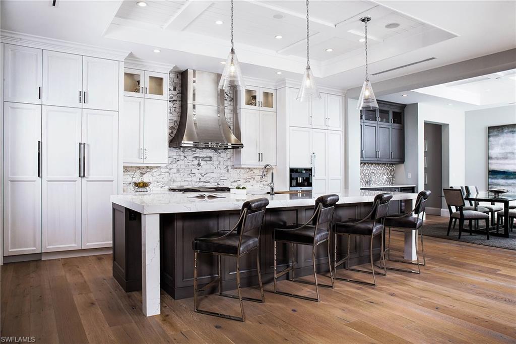 This sprawling 5,012-square-foot home is located in the heart of Olde Naples with close proximity to beautiful Gulf beaches and Fifth Avenue South. Embrace the Florida lifestyle from this home’s expansive outdoor living area with pool and spa, summer kitchen, and covered and uncovered seating areas all accented by the glow of fire bowls. This new construction home features wide-plank hardwood flooring, tankless hot water systems, a camera security system, five bedrooms, five plus two-half baths, a den and guest casita. The custom glass wine room is designed with a stylish, contemporary wine rack featuring a sensory driven climate controlled chilling system. The chef will enjoy the Miele® appliances, quartz countertops and custom-built cabinets. Entertain with ease with a large open concept floor plan transitions seamlessly to stunning outdoor spaces. This home showcases the best of Florida living indoors and out.
