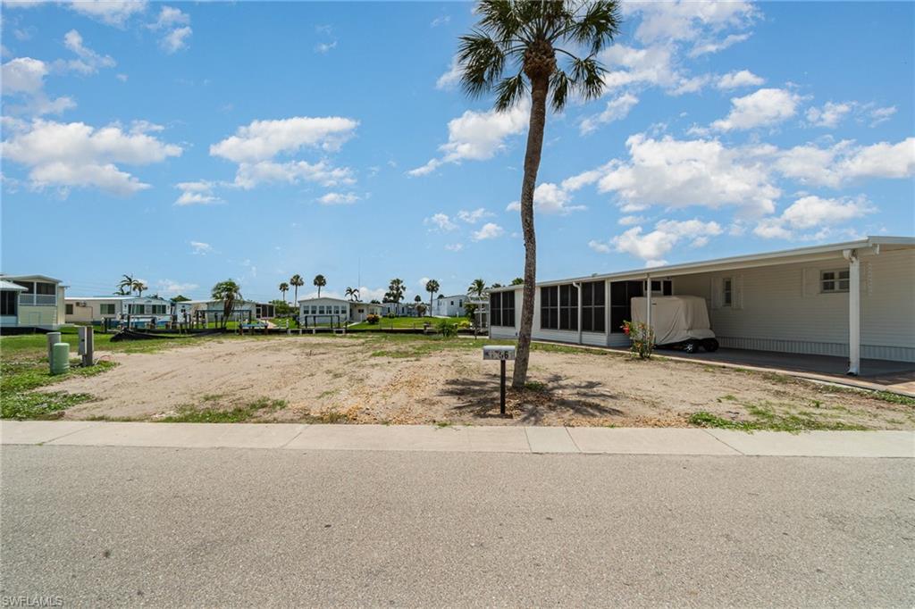 Seller Financing.  Build to Suit!  A competitively priced opportunity to build your dream tropical oasis in Bayside Estates, a vibrant 55+ boating community just 2.5 miles from the white sands of Fort Myers Beach. This prime lot is perfectly situated just steps from the clubhouse and pool, offering effortless access to relaxation and a variety of social activities. The property's dock, which survived Hurricane Ian, provides direct Gulf access for endless boating adventures. Residents enjoy a low-maintenance lifestyle with a low HOA fee that includes lawn care, water, sewer, internet, reclaimed irrigation, and onsite management. With a full calendar of planned community events, Bayside Estates fosters a strong sense of connection and camaraderie among neighbors. Surrounded by lush tropical landscaping and welcoming residents, this is your chance to create a luxurious retreat in a peaceful, amenity-rich setting. Don’t miss the opportunity to bring your vision to life in one of Southwest Florida’s most desirable coastal communities.