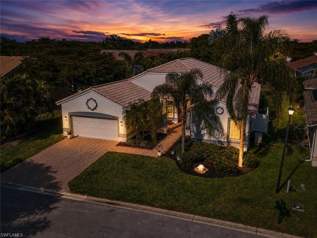Welcome to this luxurious, meticulously maintained home in the highly sought-after 55+ gated community of Cascades at Estero, offering over 2,600 square feet of thoughtfully designed living space. This highly desirable floor plan is considered the Queen of the community for its spacious layout, versatility, and exceptional value compared to similar homes in neighboring luxury communities. Rarely available and truly move-in ready, this residence is ideal for buyers seeking resort-style Southwest Florida living with premium upgrades, low-maintenance convenience, and complete hurricane protection already in place. A standout feature is the private tropical outdoor oasis showcasing a heated saltwater in-ground pool and relaxing spa with spillover, all enclosed within an expansive covered screened lanai designed for year-round Florida living. The oversized outdoor living area offers multiple entertaining and lounging spaces perfect for outdoor dining, hosting guests, or relaxing in privacy. This beautifully upgraded home features 3 spacious bedrooms, 2.5 baths, and a versatile bonus room adjoining the primary suite—ideal for a home office, fitness room, media room, or private retreat—with custom built-in cabinetry and drawer storage. Mature tropical landscaping and exceptional curb appeal create a stunning first impression. Inside, the bright open-concept layout showcases designer updates throughout including plantation shutters, crown molding, newer interior and exterior paint, tile flooring in the main living areas, luxury vinyl plank flooring in the bedrooms, updated lighting fixtures, energy-efficient ceiling fans, and upgraded hardware throughout. The chef-inspired kitchen has been beautifully updated with refaced cabinetry featuring crown molding, soft-close doors, quartz countertops, designer backsplash, updated faucets and sinks, newer stainless steel appliances, and pull-out drawers with pull-out pantry shelving for exceptional organization and convenience. The spacious primary suite offers two oversized walk-in closets and a renovated spa-like bathroom with dual floating vanities, quartz countertops, custom mirrored cabinetry, updated tile, upgraded sinks and faucets, and an oversized walk-in shower. Additional bathrooms have also been stylishly updated. Additional highlights include a whole-house generator with buried propane tank, electric roll-down hurricane shutters on the front and rear of the home, accordion hurricane shutters on the windows, 2020 A/C system, 2023 water heater, spacious laundry room with utility sink, hanging garage storage, and attached two-car garage. Residents of Cascades at Estero enjoy resort-style amenities including a grand clubhouse, pool and spa, fitness center, tennis, pickleball, bocce, social clubs, and a full calendar of activities. Conveniently located near beaches, Malls, dining, golf, and SWFL Intl Airport, this exceptional property offers luxury, location, lifestyle, and true pride of ownership.
