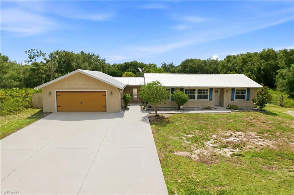 If you've been waiting for the right Alva property to hit the market, your search may be over!!!Not often does a property offer this combination of privacy, storage, outdoor living, and expansion potential on a half-acre homesite in Alva.

Situated on a HALF-ACRE homesite in FLOOD ZONE "X", this 3-bedroom, 2-bath home features a split-bedroom floor plan, an OVERSIZED DETACHED 2-car garage, and room for boats, RVs, trailers, and additional vehicles. Located on a dead-end road with only one other home on the street, this property offers privacy while remaining convenient to shopping, dining, schools, and everyday amenities.

Interior features include tile flooring in the main living area, LVP in the bedrooms, crown molding, Hunter Douglas plantation shutters, Hunter Douglas motorized Silhouette shades, ceiling fans throughout, and a family room with a pallet-board accent wall, large picture window overlooking the backyard, and sliding glass doors leading to the covered and screened lanai.

The galley kitchen offers real wood cabinetry, granite countertops, updated appliances, breakfast bar seating for three, and a Culligan reverse osmosis system. Both bathrooms have been tastefully updated. The primary suite features a walk-in closet with custom shelving and organizers, along with a spacious primary bathroom featuring an updated walk-in shower.

Major improvements include a 5V metal roof-over completed in 2014, Hardee Board Siding, PGT windows, updated ductwork, water treatment system replaced in 2020, water heater approximately 5 years old, garage door springs replaced in 2019, and Blink security cameras around the exterior.

The outdoor living area includes a large covered and screened lanai with travertine tile flooring, tongue-and-groove ceilings, and ample space for outdoor dining, entertaining, and relaxing. A covered breezeway with a matching tongue-and-groove ceiling connects the home to the detached garage.

The oversized detached garage offers ample room for vehicles, storage, workshop space, hobbies, collectibles, or recreational equipment. The expansive driveway provides parking for boats, RVs, trailers, and multiple vehicles. There is a 50-amp plug for an RV.  Additional exterior features include a hurricane-anchored 20' x 40' Carolina carport and a detached enclosed shed for additional storage.

Bring the kids, chickens, boats, RVs, and all the toys. With a half-acre homesite, oversized garage, covered parking, outdoor living space, and numerous updates already completed, this property embodies the lifestyle that draws so many buyers to Alva.