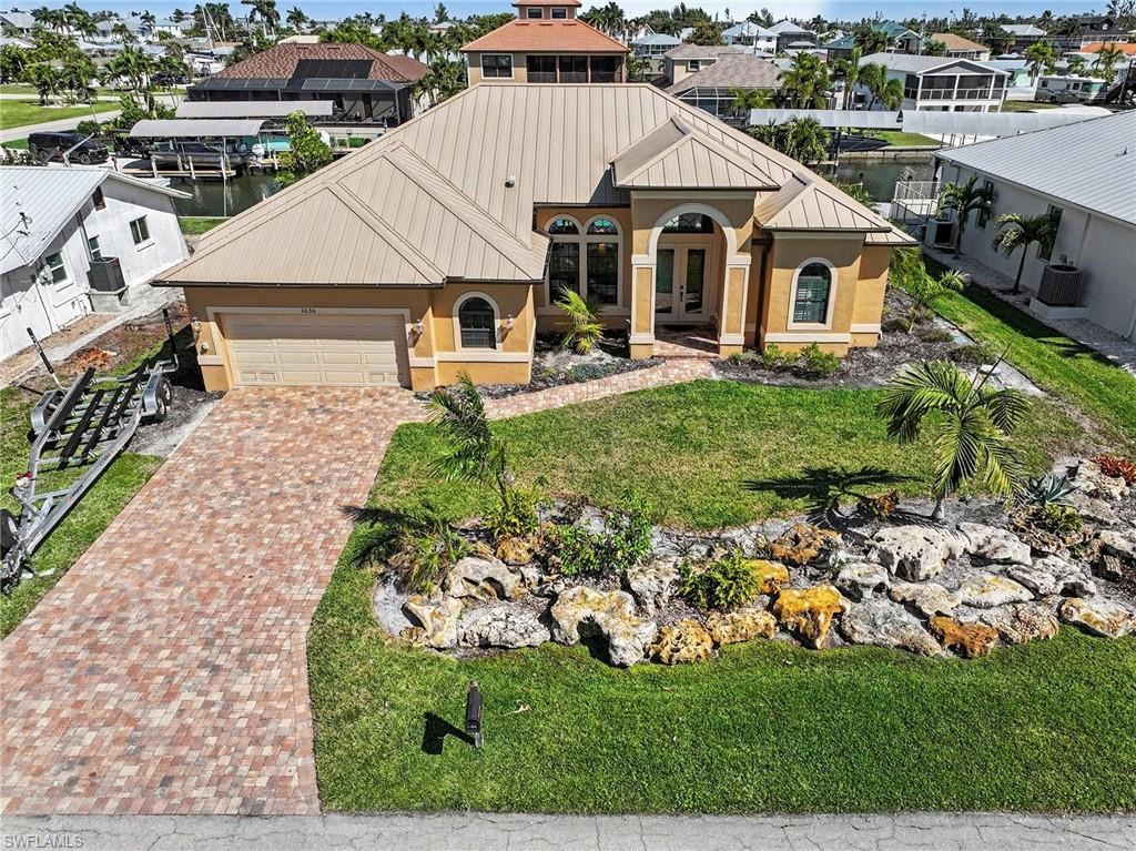 Highlights: Over 100 feet of brand-new composite dock & pilings • Dual 14,000 lb boat lifts • Fully furnished, turnkey • Never flooded • Expansive outdoor entertaining area • Quick Gulf access

Welcome to your island escape at 3656 Emerald Ave in the heart of St. James City on beautiful Pine Island—where the pace slows down, the sunsets feel a little brighter, and life revolves around the water.
From the moment you arrive, you’ll feel the easy rhythm of true island living. This waterfront retreat is designed to enjoy the coastal lifestyle to its fullest, whether you're heading out for an early-morning fishing trip or gathering with friends as the sky turns shades of orange and pink over the water.
Step outside and you’ll discover what truly makes this property special, with over 100 feet of brand-new composite dock stretching along the waterfront, complete with two new 14,000lb boat lifts so your boats are always ready for adventure. With quick access to some of Southwest Florida’s most incredible fishing and boating waters, days spent exploring the surrounding islands, sandbars, and the open waters of the nearby Gulf are simply part of everyday life here.
The expansive outdoor entertaining area poolside invites you to relax, grill fresh-caught fish, host sunset cocktails, or simply unwind while watching boats drift by. It’s the kind of space where memories are made—barefoot evenings, salty breezes, and laughter carrying across the water.
Inside, the home is being sold fully furnished, allowing you to step right into the island lifestyle from day one. Light-filled living spaces create a welcoming atmosphere that feels both comfortable and coastal, making it the perfect retreat after a day on the water. Featuring an open floor plan with 2 bedrooms with pool access and a third bedroom for all of your guests. The master ensuite bathroom has a deep soaking tub, large walk-in shower, dual sinks, and dual walk-in closets for the perfect coastal retreat.  The second bath has pool access, making it easy to transition from boating and the pool to being ready for all that Saint James City has to offer. 
For added peace of mind, the home has never flooded, offering confidence along with its incredible waterfront setting. 
Tucked into the charming community of St. James City, you’re just moments from local marinas, waterfront restaurants, and the laid-back island culture that makes Pine Island so beloved. Here, neighbors wave as they pass by the boat, fishing stories are traded at sunset, and every day feels a little like vacation.
If you’ve been dreaming of a place where boating, fishing, and waterfront living come naturally, 3656 Emerald Ave is more than a home; it’s your gateway to island life.