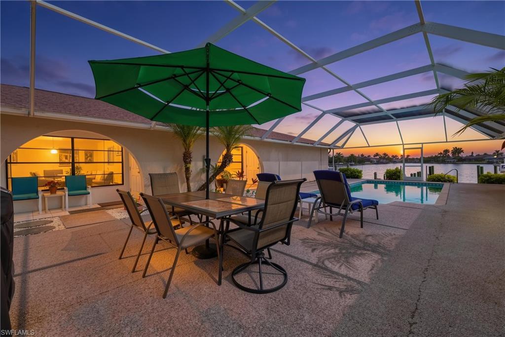 WATERFRONT GULF ACCESS CONDO NO BRIDGES NO CDD NEW ROOF, rare opportunity to own in a four unit low density waterfront community designed for true coastal living, ideally located within walking distance to Publix and just minutes from downtown Cape Coral, Bimini Basin, Slipaway Food Truck Park Marina, and The Cove featuring Aqua Rooftop Bar and nearby waterfront dining, this residence sits in the heart of Cape Coral’s fastest growing entertainment corridor with direct Gulf access from your private boat slip, with only four owners this intimate community offers a private pool creating a quiet resort style setting and boutique waterfront living, NO RENTAL RESTRICTIONS, NO AGE RESTRICTIONS, and pets allowed with approval, the home features an open concept layout with seamless indoor outdoor flow through private sliding glass doors to a screened covered lanai ideal for enjoying the coastal breeze and relaxed Florida lifestyle, the split bedroom floor plan provides privacy with an ensuite primary bedroom and a spacious light filled living area ideal for entertaining or relaxing, the kitchen features updated cabinetry and connects to a convenient laundry area, both bathrooms feature updated cabinetry with granite countertops delivering a clean modern coastal finish throughout, tile flooring runs throughout the home for easy maintenance, additional highlights include a rare opportunity to own your private boat slip, enjoy nightly sunsets over the water, watch dolphins and manatees play, fish from the community dock, or launch a kayak for a peaceful paddle through the waterways, offering an unmatched blend of boating access, waterfront tranquility, and walkable convenience in one of Cape Coral’s most desirable locations.
