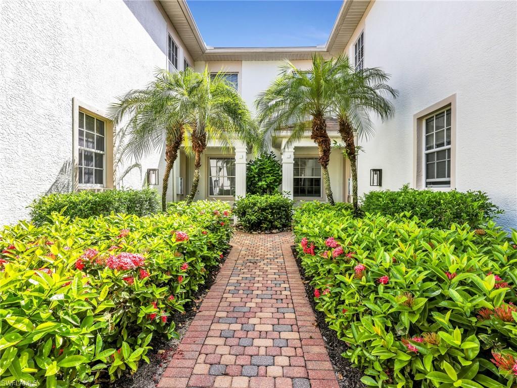 Experience effortless living in this updated first-floor coach home in Wellington Place at Kensington Golf & Country Club. Offering 2 bedrooms plus a versatile den, 2 bathrooms, and a spacious two-car garage, this coastal contemporary residence combines timeless style with an exceptionally flexible floor plan designed to adapt to your lifestyle. Warm wood-look tile flooring flows throughout the home, complemented by plantation shutters, soft neutral finishes, and an abundance of natural light. The open-concept kitchen is thoughtfully designed with quartz countertops, a center island, built-in breakfast seating, and seamless connectivity to the surrounding living spaces. Pocketing sliding glass doors extend the living area to the screened lanai, where tranquil lake views create the perfect backdrop for morning coffee or evening relaxation. The flexible layout offers multiple options to suit your needs. The den is currently furnished as a guest bedroom, while the formal dining room is being utilized as a home office, providing exceptional versatility for remote work, hobbies, or additional guest accommodations. The spacious primary suite overlooks the lake and features a generously sized bathroom with dual vanities, a soaking tub, walk-in shower, and newly installed countertops—the home's most recent update. A private guest bedroom and full bath offer comfort and privacy for family and visitors alike. Ideally situated within the community, this residence enjoys convenient proximity to the neighborhood clubhouse, resort-style pool, and fitness room while maintaining a peaceful, private setting away from the activity. Located in the prestigious Kensington Golf & Country Club, this exceptional coach home places you just minutes from Naples' renowned beaches, Waterside Shops, Mercato, Old Naples, fine dining, shopping, and everyday conveniences. Golf membership is optional, allowing you to enjoy the Kensington lifestyle with the flexibility to choose the membership that best suits your needs.