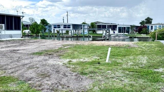 AMAZING WATERFRONT LOT with Direct Gulf Access for your new Mobile Home.  Canal/water view on one side and small community park area across the street.  There is a dock/lift but does need repair.  Located right off the Caloosahatchee River in Old Bridge Village.  Old Bridge Village, is a friendly, 55+ resident owned community right off the Caloosahatchee River and Gulf Access with lots of amenities, activities all year, clubs and entertainment.  There is a resort style brand new Salt-water heated pool and hot tub, fitness center, recreation center, bocce ball, pickleball, shuffleboard, tennis, basketball, putting green, horseshoe pits, community clubhouse, fishing pier, kayak and boat launch and an 81 slip marina.   Drive your golf cart around the community, to and from your activities or to Palm Point where you can fish, have a picnic, watch the boats or just enjoy the sunset.  This community is a hidden gem with just minutes by boat or car to downtown Ft. Myers and right between 2 airports with approximately 30 minutes to both Southwest Florida International Airport and Punta Gorda Airport.