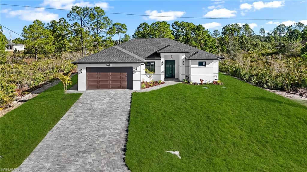 Brand-New Construction in Lehigh Acres! This beautifully designed 3-bedroom, 2-bath home with a den offers a functional split-bedroom floor plan and modern finishes throughout. Thoughtfully crafted with attention to detail, the home features custom kitchen cabinetry, custom closets, high ceilings, and an open-concept living area filled with natural light.

The kitchen comes fully equipped with all appliances, including a washer and dryer, making this home truly move-in ready. Additional upgrades include impact-resistant windows and doors, a paver driveway, and an automatic irrigation system.

One of the guest bedrooms offers a unique opportunity for multi-generational living or additional flexibility, featuring a private exterior entrance with the potential to be converted into a future in-law suite or private guest quarters.

Situated in Flood Zone X, flood insurance is not required by most lenders. Conveniently located on a quiet street ending in a cul-de-sac, this property provides privacy while remaining close to schools, parks, shopping, dining, and the growing commercial developments that continue to enhance the area.

Don't miss the opportunity to own a brand-new home in one of Southwest Florida's fastest-growing communities. Seller will contribute towards closing costs $$$!