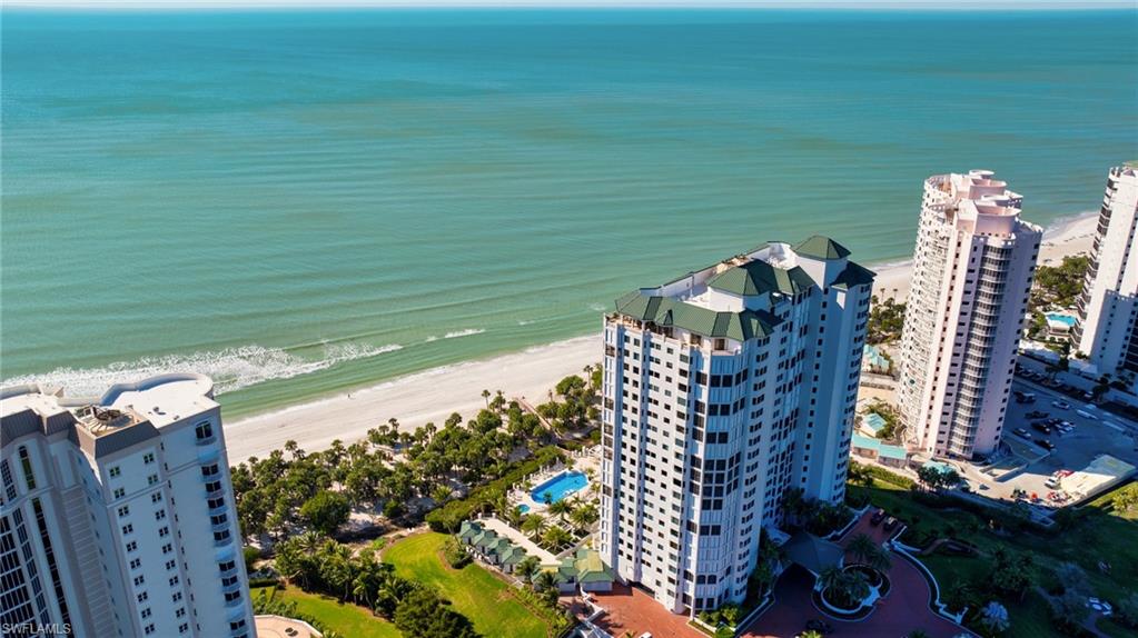 Direct beachfront luxury condo. Fully renovated with wood floors throughout, new kitchen with white quartz countertops and renovated baths. Impact windows and automated shutters on the lanai. Family room has beautiful new wood beams on the ceiling. Offering over 2,600 square feet of living space, this stunning condo feels like a single-family home, with panoramic Gulf views and refreshing trade winds from nearly every room. Enjoy the sugar sand beach right at your doorstep and experience front-row views of majestic sunrises and sunsets from the comfort of your two screened lanais. The Carlysle is among the most desirable buildings in Bay Colony, having just completed a fully remodel of the gorgeous lobby, new saltwater pool and spa, exercise room, manned front desk, two guest suites, bike storage, social rooms. From the grand lobby and front entrance to the refined elevator lobbies, meticulously designed driveway, and lush landscaping, every detail is truly remarkable. Residents of the Carlysle enjoy direct beach access, a beachfront pool, a well-appointed fitness center, and exclusive membership privileges at the Bay Colony Beach Club and Bay Colony Tennis. They also benefit from the full suite of lifestyle amenities within Pelican Bay, including miles of private beach, two additional beachfront restaurants, pickleball, a state-of-the-art fitness center, sailing, canoeing, miles of walking trails, and an active cultural and community scene. Parking space numbers are 90 & 116.
