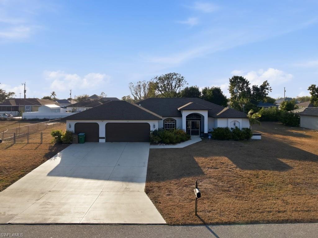 Spacious and well-maintained 4-bedroom, 2-bath pool home with a 3-car garage, offering 2,023 sq ft of living space on an oversized .36-acre lot. This property is currently operating as a short-term rental and is being offered turnkey, ideal for investors, full-time residents or your second home in paradise. This home features a desirable split floor plan with formal living and dining rooms, plus a separate family room for added flexibility. The kitchen is equipped with stainless steel appliances and overlooks the main living areas, perfect for entertaining. Enjoy Florida living at its best with a heated saltwater pool and spa, all enclosed within a large, screened lanai and covered outdoor space. The primary suite offers sliding glass doors to the pool, dual sinks, a walk-in shower, and a private water closet. Three additional guest bedrooms are generously sized, and the guest bathroom conveniently doubles as a pool bath. Additional highlights include tile flooring throughout, city water and sewer, a laundry room with utility sink, and a 3-car garage with durable epoxy flooring. A portion of the yard is fenced, perfect for pets or play while still leaving ample space for outdoor activities. Conveniently located just south of Pine Island Road, providing quick access to shopping, dining, and grocery stores, with easy commuting via US-41, Veterans Parkway, and Cape Coral Parkway. Don’t miss this opportunity to own a versatile property in a prime location.