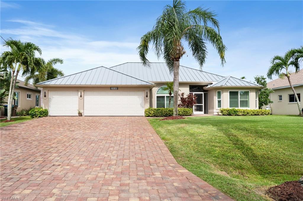 Beautifully Updated Direct Gulf Access Pool Home with No Bridges, situated on a WIDE Canal with Beautiful Water Views! Offering 3 bedrooms, 3 bathrooms, a 3-car garage, and just under 2,000 square feet of thoughtfully designed living space, the open Great Room floor plan features both formal and casual dining areas, while the split-bedroom design provides privacy for family and guests.

The kitchen and all three bathrooms have been tastefully updated within the past three years with QUARTZ COUNTERTOPS, NEW FIXTURES, and FRAMELESS GLASS SHOWER DOORS. The kitchen also features GE Profile built-in oven, cooktop, microwave, and a Bosch dishwasher. LVP flooring has been installed in the bedrooms, with tile throughout the main living areas.

The spacious primary suite offers two walk-in closets, a tray ceiling, lanai access, and a luxurious bath with dual vanities, a walk-in shower, and a relaxing jetted soaking tub. On the opposite side of the home, one guest bedroom features a private ensuite bath that also serves as the pool bath, while the third bedroom is conveniently located adjacent to the additional full bath. Multiple sliding glass doors from the Great Room, primary suite, and guest ensuite create the perfect indoor-outdoor lifestyle.

Outside, the spacious Paver Lanai provides plenty of room for outdoor dining and entertaining while overlooking the waterfront and enjoying the large heated pool. Boaters will appreciate the Composite Dock with Captain's Walk and 10,000 lb. Boat Lift, making it easy to enjoy Southwest Florida's boating lifestyle.

Recent major improvements include a 2024 STANDING SEAM METAL ROOF, IMPACT RESISTANT WINDOWS & SLIDING GLASS DOORS, a NEW LANAI CAGE with no-see-um screening (2023), FRESH EXTERIOR PAINT, MARBLE WINDOWSILLS, A/C replaced in 2018, and newer POOL HEATER & PUMP. 

City Water & Sewer Assessments are Paid, and an Affordable Assumable Flood Insurance Policy is an added bonus for qualified buyers. This gorgeous home is being offered Fully Furnished & Decorated to make your move as easy and seamless as possible.

Located in one of SW Cape Coral's most desirable neighborhoods near shopping, dining, parks, and bike paths, this Move-In Ready Waterfront Home checks all the boxes! Perfect as a primary residence, seasonal retreat, or high-end vacation rental. Don't let this one slip away! Secure your "Piece of Paradise" today!