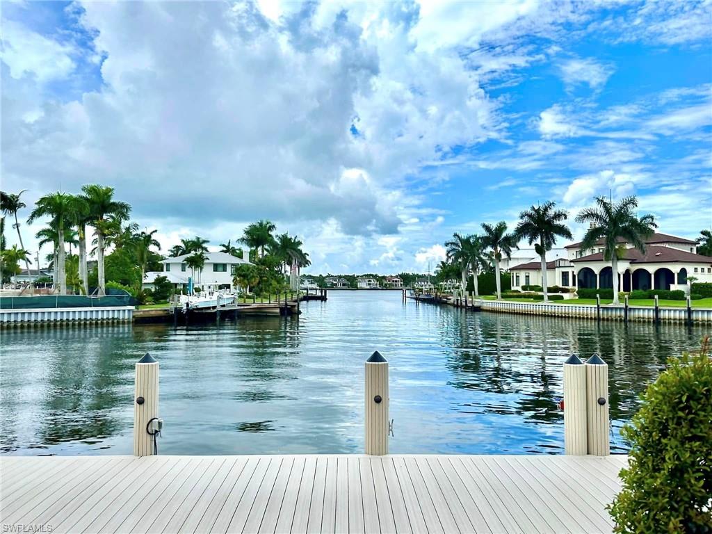 **NEW PRICE – Arguably the Best Boating Opportunity on Naples Bay!**

With over 100 feet of deep-water frontage and quick Gulf access, this exceptional property is a boater's dream. Complete with a 20,000-pound boat lift, jet ski lift, and a newer seawall, it's ready for your next adventure on the water.

The 4-bedroom + den home is equally impressive, offering ensuite bedrooms, an infinity-edge pool and spa, and stunning sunset views over Naples Bay.