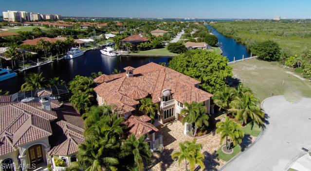 FEATURED ON HGTV – Dream Homes!!This Spectacular “TURN KEY – Totally Furnished” Luxury Residence is Beyond Compare.Deep Water Boating at its Best,accommodating up to 125+ ft Mega Yacht.Minutes out to the Inter-coastal,Bay and Gulf of Mexico. Everything is Custom Built,Designed and Finished in this home.No detail has been left out.Features include State of the Art Electronics,Incredible Home Theater,2,200 bottle wine cellar,Expansive Outdoor Areas for Entertaining with Negative Edge Pool/Spa,Full Outdoor Kitchen,Beautiful Library and Billiards Rms,Fantastic Family/Living,Dining and Kitchen areas.1st Floor Master Retreat with 5 additional Guest Suites.Marble,Onyx,Granite,Wood, Silks,Faux Painting,Gold Fixtures,etc are just some of the finishes used in this amazing property.Located close to everything SW Florida has to offer,dining,shopping beaches, incredible fishing,Major/Private Jet Port and more. A total WOW Factor and one you must see if looking in SW Florida.