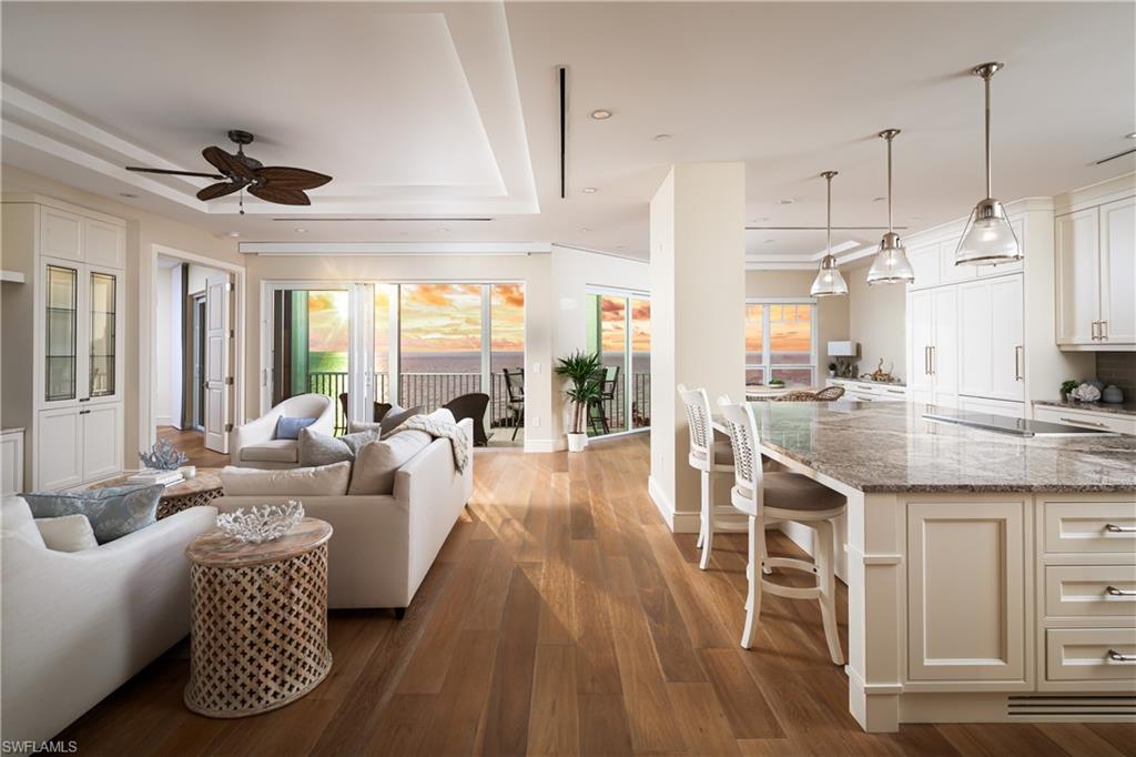 EXQUISITELY REMODELED, STATE-OF-THE-ART D-UNIT PENTHOUSE IN NORTH NAPLES’ COVETED BAREFOOT BEACH CLUB! Rarely available, this extraordinary residence offers breathtaking, unobstructed Gulf views and is the only building on the bayside with west-facing balconies, ensuring spectacular sunsets over the Gulf of Mexico year-round. This coastal contemporary masterpiece has been completely redesigned to showcase the finest features and finishes. From extra-high ceilings exclusive to penthouses which have been raised and customized with tray accents to stunning wide plank oak flooring, this penthouse has been meticulously crafted. Fully storm protected, this unit boasts new hurricane impact windows throughout, electric storm shutters, and a brand-new roof on the building! The open floor plan spans 2,266 sq ft and includes 3 spacious bedrooms, 3 luxurious bathrooms, an additional storage unit, and ample storage throughout. The chef’s kitchen is a culinary masterpiece, featuring elegant white and glass-enclosed cabinetry, an oversized granite island, dual sinks, and top-of-the-line appliances including a Miele induction cooktop, steamer oven, oven, warming oven, microwave, dishwasher, Sub-Zero refrigerator, freezer drawer unit, and a full-size wine fridge. The well-designed split floor plan offers privacy and convenience, with guest bedrooms with en-suite baths situated at the front, while the serene primary suite is positioned on the waterfront side. The primary suite is a tranquil haven with breathtaking Gulf views and private lanai access. It includes an expansive walk-in closet with custom built-ins and a spa-like bathroom with dual vanities, a standalone tub, and a spacious walk-in shower. Additional features include dual zoned HVAC systems with Nest thermostats and linear vents, new hot water heater (2024), hot water circulator, whole unit water filtration system and separate reverse osmosis system in the kitchen, UV film on all windows (2023), electric solar blinds in the living room, and custom built-in cabinets throughout. The Club at Barefoot Beach includes fine & casual dining, private pool, tennis courts, beachside food & beverage service, planned social activities & more (WITH A MEMBERSHIP). Nearby to the NEW CLUBHOUSE with state-of-the-art fitness center & resort-style pool. Enjoy 3 miles of Gulf-frontage, 2 beachside pools/spas, fitness center, 24-hour manned/gated entry & on-site mgmt. Located minutes to Mercato, Waterside & easy access to RSW Airport.