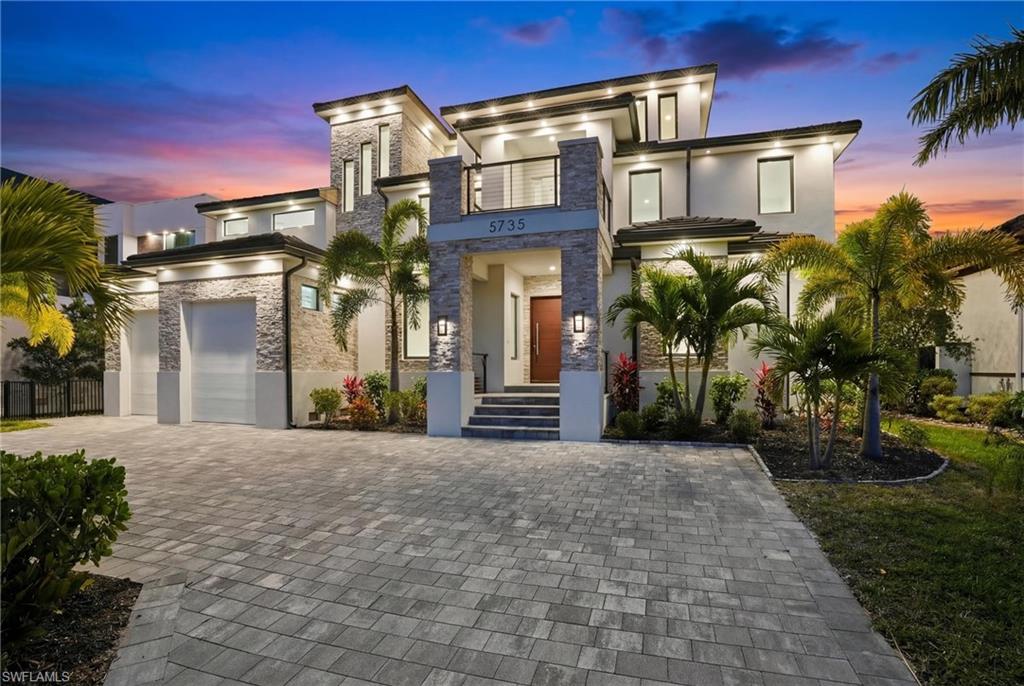 This is WOW Factor!  If you want the Biggest, Baddest House built in Cape Coral history,... then this is it !
Truly one of the most UNIQUE Waterfront Estates in all of SW Florida, this extraordinary 9,000-square-foot custom residence delivers the ultimate “Waterfront WOW Factor” here in Paradise. Engineered for strength and longevity, the home was constructed using Insulated Concrete Form (ICF) with 30ft pilings supporting both the residence and pool foundations, complemented by full IMPACT WINDOWS and expansive impact glass sliders throughout.  This house is Solid and Beautiful at the same time.
From the moment you enter through the dramatic Solid-wood pivot front door, your eyes are drawn to the breathtaking Caloosahatchee River views, framed by spectacular quad sliding doors. ITALIAN MARBLE flooring flows throughout the home, leading to Five Private Bedroom Suites - each with walk-in closets and spa-inspired full baths and walk-in showers. A first-floor Den/Office delivers flexibility, while the 2nd floor loft and 3rd floor level provide opportunities for additional bedrooms if desired. 
The Chef’s Kitchen is a true showpiece, centered around a MASSIVE island cooktop with statement hood vent, extensive illuminated cabinetry, and endless waterfront prep space. PREMIUM appliances include a Wolf double oven, Sub-Zero refrigerator, wine refrigeration, trash compactor, and even a Wolf outdoor gas grill. Additionally, an enormous walk-in butler’s pantry - designed to double as a safe room - adds both function and peace of mind.
Occupying the 2nd floor is the huge primary suite.  It is a private retreat with expansive windows and DUAL BALCONIES, capturing panoramic river views. The spa-like en-suite bath features dual vanities, a soaking Jacuzzi tub, and a spectacular 10' x 12' walk-in shower with multiple heads and body sprays.  All seamlessly connected to a personal sauna for the ultimate at-home Spa Experience. Two additional en-suite bedrooms and a loft area complete this level of the Home. A private ELEVATOR services all floors, including the expansive 1,000-square-foot 3rd floor Bonus Space - ideal for a Fitness studio, Yoga retreat, Game arena, Event venue, or additional living quarters. The Top Floor also features a dedicated theater room with custom projection system. 
The house is setup for Full smart-home wiring, Generator readiness, and Quad Zoned HVAC with separate handlers for each floor and the garage. 
Outdoor living captures the essence of Southwest Florida luxury. Travertine Tile surrounds the oversized INFINITY-EDGE pool with a huge sun shelf, perfectly positioned for sunrise coffee, sunset cocktails, and waterfront entertaining. With deep-water, no-bridge Gulf access, your boat reaches the Open Waters of the SE United States of America within minutes. This is more than a home... it is a fortified Riverfront Estate designed for luxury living in Paradise.  Come and Live the ultimate Southwest Florida lifestyle!