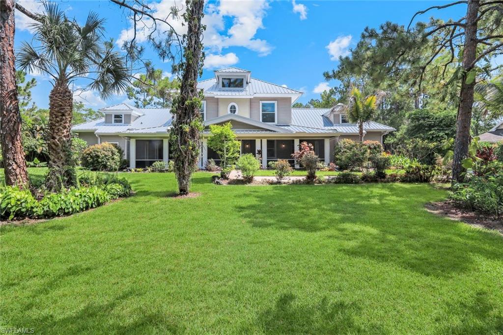A breathtaking fusion of Coastal Craftsman charm and Modern Plantation elegance, this professionally curated estate delivers a lifestyle that feels both timeless and indulgently fresh. Set on 2.5 acres of pristine, 100% uplands in Golden Gate Estates, the property unfolds with commanding symmetry, a deep wraparound style front porch, and multi tiered rooflines that create unforgettable curb appeal the moment you arrive.
Step inside and the drama builds instantly — a soaring 22’ vaulted great room, spacious foyer, and beautifully scaled formal living and dining spaces create an atmosphere that’s equal parts grand and welcoming. The gourmet kitchen is designed for those who love to gather, featuring granite countertops, wall oven with convection/microwave, electric cooktop, and a spacious, intuitive layout that makes entertaining effortless.
The owner’s suite is a true retreat, offering dual vanities, a jetted soaking tub, a large walk in shower, and refined finishes that elevate everyday living. Throughout the home, thoughtful upgrades add comfort and peace of mind: impact windows and shutters, whole house reverse osmosis, EV charging station installed by FPL, and natural gas available at the street.
Outdoor living becomes a daily luxury with a sparkling inground pool and a beautifully crafted cozy sitooterie—a peaceful outdoor nook designed for relaxing, reading, or enjoying the surrounding acreage. With no HOA restrictions, the acreage offers freedom, privacy, and endless possibilities.
Boasting 3,424 A/C sq ft and 5,320 total sq ft, this estate embodies the best of Naples living — space, serenity, architectural character, and proximity to shopping, dining, and world class beaches. It’s not just a home; it’s a destination.