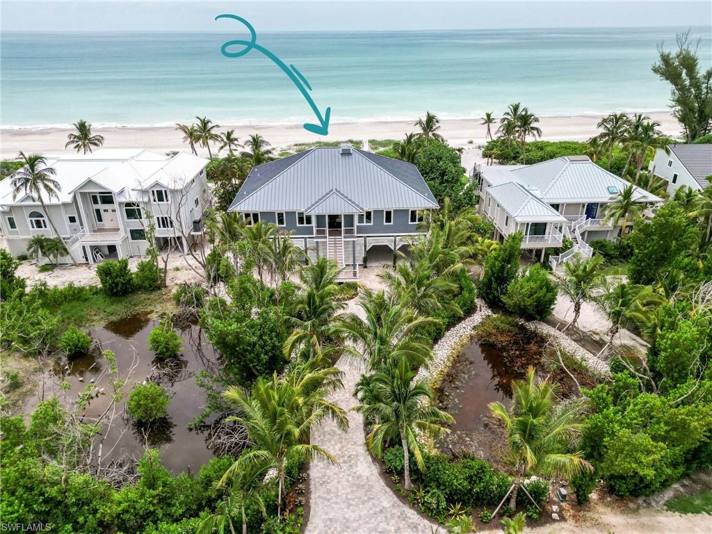 SOSIANNA - the epitome of coastal luxury! This stunning 5-bedroom+Den, 4.5-bathroom home, is situated within the gates of South Seas Resort. Masterfully designed and renovated, this residence features only the finest materials and finishes. Enjoy the durability and style of a standing seam aluminum roof, Hardie board siding, and hurricane-rated impact windows. The property also includes a commercial 45kW generator, aluminum railings, multi-level decks and premium composite decking. Inside, savor panoramic Gulf views from your spacious living areas adorned white oak wood flooring, shaker wood cabinetry, and linear fireplace. The culinary kitchen boasts quanta quartz waterfall island and countertops, Blue Wave glass backsplash, Audra Pendant lighting, premium appliances including beverage cooler and drawers.  Coastal side den exudes tailor-made cabinetry, Bastian over-size chandelier, and stunning vistas! The guest suite is beyond the elevator providing its own privacy wing.   Meticulously crafted landscaping and lighting for an impeccably manicured ambiance combined with security cameras.  Situated on one of the most coveted private streets, this property offers unparalleled proximity to the beach, complete with a private pool, tennis courts, and pickleball courts.   Despite the serene privacy, you're just steps from the beach and minutes from renowned restaurants, retail shops, and a variety of outdoor activities. Embrace coastal living at its finest in this exquisite Captiva home.