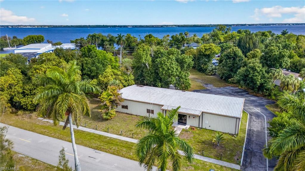 Opportunity is knocking with this rarely available versatile property! Able to accommodate a variety of uses, as well as the ability to remodel to include additional income opportunities, this property will not disappoint. Currently home to the Fort Myers Power Squadron, this open concept building could be the home to your new investment, business, multifamily project and more. With 279 units approved for development across the street, there is a tremendous potential for visibility and additional income streams. The property backs up to East Riverside Drive as well as frontage on Royalston Avenue, allowing you to conform the property for additional uses. Additionally, there is also an outbuilding for storage. Please note there are several leases for events that are transferrable to the new buyer or terminated upon sale.