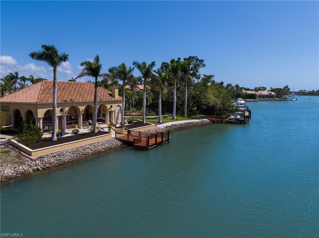 Double lot, 220' +/- water frontage, 1.1 +/- acres, spectacular offering first time to market. Truly re-mastered by Carlson Harris … extraordinary waterfront estate. Surround yourself with mature exquisite plantings creating unsurpassed privacy. Magnificent Cuban Bay Laurel tree shading the southwest property corner along the waterfront. Graceful clean lines, wide open welcoming spaces, raised ceilings, high artisanship throughout. As you pass through the mosaic tiled arches & fountain in the entry courtyard, and then open the arched mahogany front door you know this alluring  residence is an absolute pleasure to experience. Ultimate pool / spa / lanai area with vaulted exposed beam ceilings, retractable motorized screens & storm shutters, pocketing 10’ sliders across the rear of the home with sliding plantation shutters, cozy seating area with fireplace overlooking gorgeous grounds & the waterfront. Outside, experience transcendent walking garden areas with pathways, circulating pond, & amazing firepit area. For those who love to entertain prepare to be delighted whether you are having a small intimate gathering of family & friends or a pull out all the stops grand event.