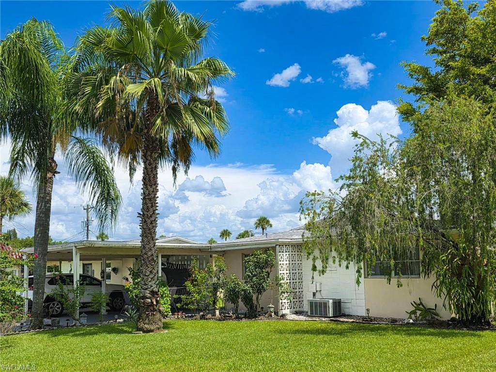 Affordable Florida living awaits in this well-maintained 2-bedroom, 1-bath first floor villa located in Camille Gardens, a friendly, 55+ adult community. At least one resident must be 55 years of age or older to qualify (additional occupancy requirements apply). Pets are welcome.

This concrete block home in central Lehigh Acres offers 1,092 square feet of bright, comfortable air-conditioned living space on a 7,187-square-foot corner lot that does not require flood insurance (located in Zone X). Positioned on a quiet circle with no through traffic, this desirable end unit feels like a single-family home and features landscaped views, abundant green space behind the home, added privacy, and a clean, well-kept yard. The property is being offered turnkey, including furniture, cookware, and household items, making it truly move-in ready.

The spacious living and dining area is adjacent to a kitchen featuring ample cabinet space, a range, microwave, and refrigerator. Both bedrooms offer ample closet space and plenty of natural light.

The concrete block Florida Room with manual shutters provides additional living space for relaxing or entertaining year-round. Outside, you'll find an attached covered carport, additional driveway parking and two exterior utility rooms (storage / laundry). Roof was replaced in 2017 and home is connected to central water and sewer. Association fees at Camille Gardens include lawn care and exterior painting.

Lovingly used as a vacation home for the past 25 years, this home has been exceptionally well cared for. The owners are now returning to Europe and are offering their cherished Florida home for sale. Enjoy comfortable, low-maintenance living year-round or seasonally in beautiful Southwest Florida - perfect for part-time residents or out-of-state-buyers. Don't miss this opportunity to own your own piece of paradise. Schedule your showing today!