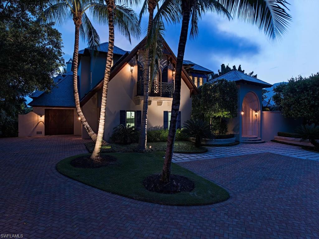 Beautiful private estate.  This custom home was designed by Harrell & Co. architects and built by BCB.  Hand scraped walnut floors with extensive mill work.   Electric powered sliding glass doors seamlessly join the indoor and outdoor living areas.   The lush landscaping provides privacy around the disappearing edge pool & spa.  Great outdoor entertaining with fireplace and outdoor kitchen.  Electric shutters and screens for the lanai.  Quick access to the Gulf Of Mexico from your 65 ft dock.  Immediate membership to The Port Royal Club available.