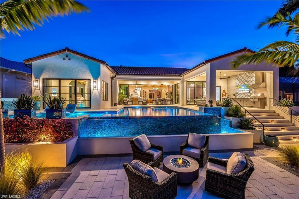 This stunning home boasts an open floor plan with plenty of natural light and 3 bedrooms + den, 4 bathrooms, and a variety of luxurious upgrades. Enjoy postcard-worthy views from the white oak flooring, PGT Aluminum Impact windows and doors, Wolf and Subzero appliances, and a Pentair filtered water system for the water and ice maker in the spacious Butler's Pantry with double beverage fridges and a walnut waterfall island sitting area. The home also features custom floating vanities in the master and suites, a custom concrete handmade ramp sink in the pool bathroom, custom master closet cabinets, and Hans Grohe fixtures and a teak ceiling in the wet room with private living space in the master wing. Entertain in style with an infinity-edge pool and spa with breathtaking views of the river or relax in the vast covered lanai space and cabana. This home also includes a new concrete seawall, maintenance-free dock with shore power and fresh water, and a 16,000lb lift. The enormous 40x26 climate-controlled garage with custom storage cabinet system completes this meticulously maintained property in a sought-after community. Don't miss out on this rare opportunity!