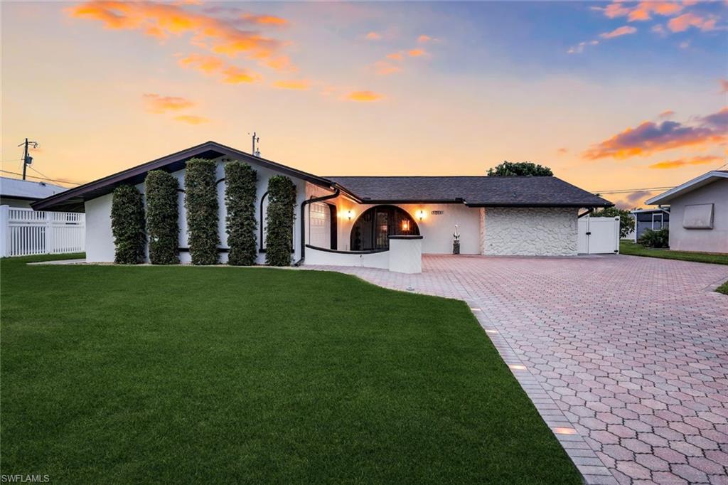 Welcome to this charming and beautifully updated Cape Coral home, ideally located in the heart of Downtown Cape Coral. Offering over 2,200 square feet of thoughtfully designed living space, this home features a unique and inviting floor plan with divided living areas—perfect for a growing family, entertaining guests, or use as a potential vacation rental. *Furnishings are negotiable 

The spacious primary suite serves as a true retreat, overlooking the pool and featuring a huge walk-in closet along with a double-sink vanity. The split-bedroom layout provides added privacy with two generously sized guest bedrooms, including one with its own en suite bathroom, plus an additional guest bath with a double vanity.

The kitchen is both functional and beautifully equipped with KitchenAid appliances, convenient pull-out storage drawers, and a lazy Susan for optimal organization and ease of use. Throughout the home, you’ll find abundant storage space, including an oversized laundry room complete with extensive shelving, an additional refrigerator, and a utility sink.

Additional interior upgrades include new flooring in the storage room.

Parking and storage are exceptional with an oversized two-and-a-half-car garage, large driveway, and covered carport.

Step outside to your private backyard oasis featuring a large heated pool with highly desirable western exposure—perfect for enjoying year-round sunshine and breathtaking Florida sunsets. The spacious covered lanai creates the ideal setting for entertaining and relaxing. The pool enclosure screen was newly replaced in 2025 along with a brand new baby gate for added convenience and safety.

The exterior of the home has been beautifully refreshed with new exterior paint, new front exterior lighting, and low-voltage exterior landscape lighting that enhances the home’s curb appeal in the evenings. Major updates include a new roof installed in 2024, offering long-term peace of mind. Even more reassuring, the property did NOT have any flooding during any hurricanes.

Located just a short walk from the vibrant and rapidly growing Downtown Cape Coral area, you’ll enjoy easy access to restaurants, shopping, entertainment, and waterfront attractions.

This move-in-ready home perfectly combines charm, functionality, upgrades, and location—don’t miss the opportunity to make it yours.