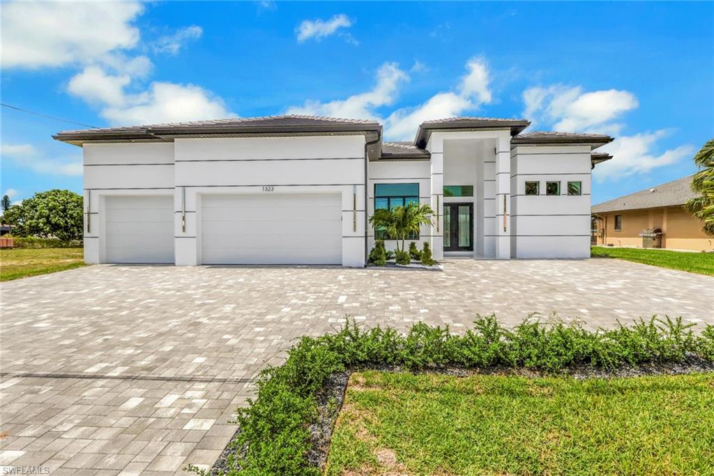 Welcome to this stunning 5 bedroom, 3.5 bathroom Gulf access home located on an oversized lot in a quiet and highly desirable neighborhood. Perfectly positioned close to everything, this location offers convenient access to shopping, dining, entertainment, everyday essentials, and the bridge over to Fort Myers.

Designed with modern luxury, space, and indoor outdoor living in mind, this home makes an impression from the moment you walk through the door. Inside, you’ll find 14 foot ceilings throughout the entire home, enhanced by beautiful 15 foot tray ceilings that add depth, elegance, and a true custom home feel. The open concept layout features sleek high end finishes, glossy tile flooring, a custom entertainment wall, and a showpiece kitchen with a large waterfall island, custom cabinetry, premium appliances, and bold black and white designer accents.

The main living area is designed to open beautifully to the outdoor space with 90 degree corner sliders, creating a seamless transition between the interior, covered lanai, pool, and backyard retreat. This feature brings in incredible natural light and makes the home ideal for entertaining and enjoying the Florida lifestyle.

This home offers two private master suites, positioned on opposite sides of the home, both with direct access to the pool area. This layout is perfect for privacy, guests, or multi generational living.

Step outside to your private backyard retreat featuring a resort style pool and spa, spacious covered lanai, outdoor kitchen, fireplace feature, and a separate pool bathroom for added convenience. Whether you’re entertaining or relaxing, this outdoor space delivers the Florida lifestyle at its best.

The home also features an oversized 3 car garage with the space and ceiling height to accommodate a car lift, along with an expansive driveway measuring approximately 62.5’ x 25.5’, offering plenty of room for multiple vehicles, guests, storage, and everyday convenience.

With Gulf access, an oversized lot, 5 bedrooms, dual master suites, 14 foot ceilings, 15 foot tray ceiling details, 90 degree corner sliders, an oversized garage, expansive driveway, and a convenient location close to everything, this home brings together luxury, lifestyle, and functionality in one incredible package.