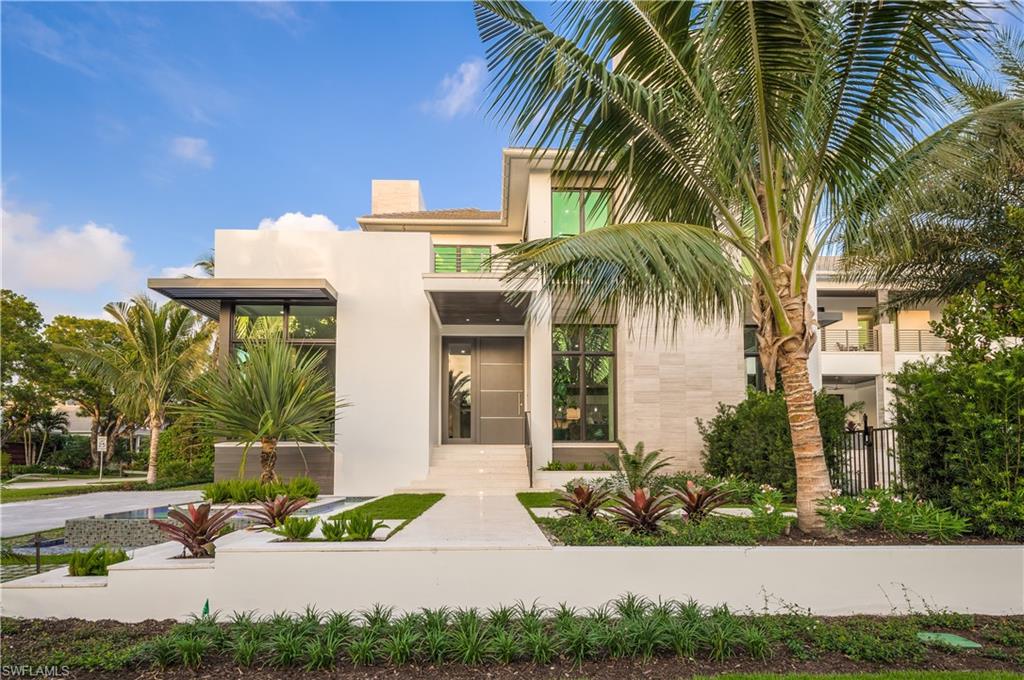 Recently completed, this gorgeous one-of-a-kind 5896* sq. ft. under air (7953* sq. ft. total) home is perfectly located in the heart of Olde Naples, just 2 homes from the beach and 2 blocks from 5th Avenue South. The home features exquisite interior finishes, four full bedrooms including two master suites, a den (or fifth bedroom), loft, five full baths, one half bath, an elevator, and an extensive pool complex with spa, outdoor kitchen and bar, outdoor fire pit and lounge. Inside, the stunning kitchen includes ample storage and appliances such as a 60-inch duel fuel Wolf range, a 60-inch Subzero refrigerator/freezer, two pullout refrigerator drawers, two dishwashers, a warming drawer, coffee maker, steam oven, microwave and walk-in pantry. The bar includes an icemaker, two 30-inch full height wine coolers, a beverage center and a Dacor wine dispenser. The spectacular great room capitalizes on views of the pool area and includes 12-foot ceilings and a linear fireplace with polished quartz surrounds. In addition, the property features a second story turf deck and a full 3.5-car garage with access to 2.5.  Spectacular southwestern exposure adds to the perfect resort-style experience.