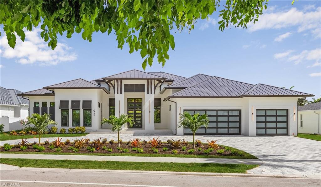 This new construction home located just a half mile from the Gulf has custom touches & features throughout. The great room contains wide plank oak flooring, designer lighting, an 18-foot vaulted ceiling & 20-feet of sliders. The Chef’s kitchen has SubZero & Wolf appliances, an 11-foot island, hidden pantry and a Butler’s pantry. This home is an entertainer’s dream with seamless access from the living spaces to an outdoor oasis. There is a large pool with a spa, a fire pit adjacent to swim-up bar stools. It also possess a covered lanai boasting a TV, fireplace and plenty of seating. The primary suite spotlights vaulted ceilings, a spacious seating area and two enormous custom built closets. The spa-like bathroom features a wetroom with a large soaker tub & multiple shower heads. The four additional guest rooms are all en-suite with custom designed closets. One of the bedrooms offers a private entrance from the front porch, making it a great office space as well. The elegantly furnished by Robb & Stucky house was built by 2022 Sand Dollar Award winner DeAngelis Custom Homes with design by LDD Interiors. This home is eligible for the Moorings Private Beach access.