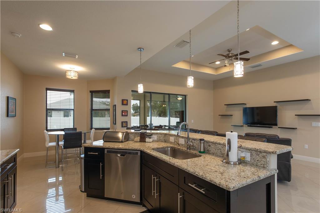 This gorgeous 3/2 home is better than new with title insurance and doc stamps paid by Seller, window coverings in place and a fully fenced yard with 6' vinyl fencing. This home built in 2017 boasts many upgrades over builder basics like 8 foot doors, large format porcelain tile throughout the entire house, tray ceilings, stainless appliances including a French door refrigerator, upgraded cabinets, full slab kitchen island with large deep sink, upgraded lighting fixtures, upgraded modern fans, tile tub surrounds to the ceilings, granite tops in both baths, many recessed ceiling lights and a 44 foot long paver driveway for ample parking. Location is in a quiet neighborhood with many newer homes and is within 5 minutes to shopping and dining destinations. No flood insurance is needed at this address. If you're thinking of building a new home you owe it to yourself to schedule a visit and see this one with your favorite Realtor soon!!! Assessments are in and paid in full!!! 3 Golf Courses nearby! Call today!