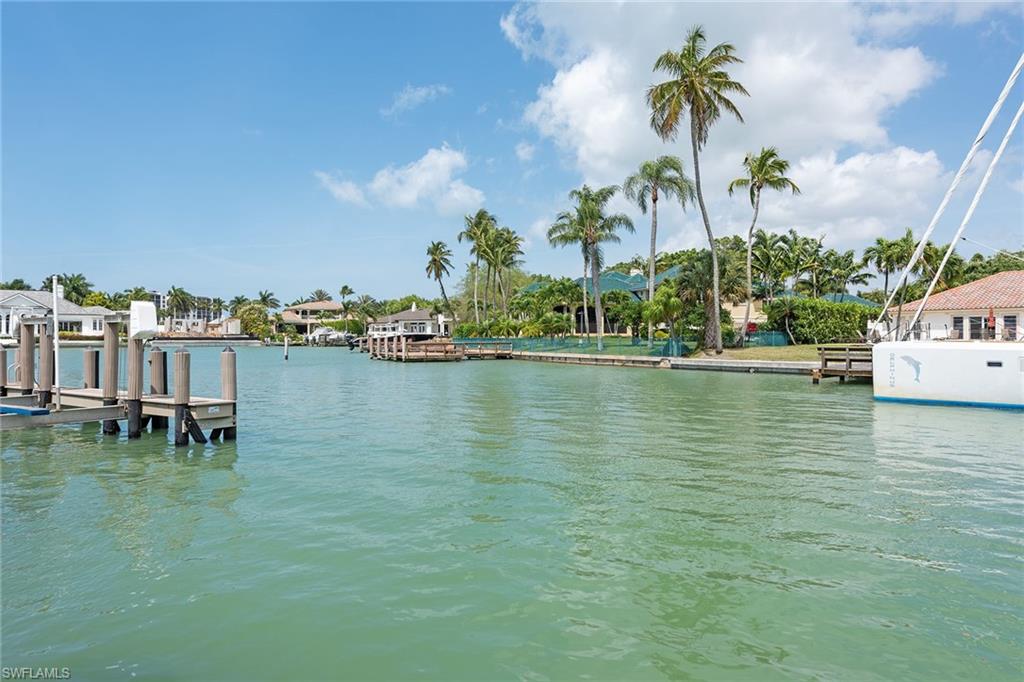 Here is your chance to purchase in one of the most desirable locations in the Moorings. This turnkey furnished four-bedroom, three-bath home is situated on a 0.36-acre lot with 110 feet of water frontage with a seawall and refurbished dock. Boaters will enjoy direct access to the Gulf without crossing under any bridges. It is also just a five-minute walk to the private Moorings beach access. The current home offers a large, open layout and has been nicely updated with solid wood flooring, new paint, new carpet, an expansive, updated kitchen featuring professional-grade appliances with gas cooking, a new AC system and newer pool heater. Out back, one will find a sizable backyard with an open-air pool, updated landscaping and beautiful water views. One can easily enjoy this home and its location and eventually build their dream home if they choose. This amazing opportunity will not last long.