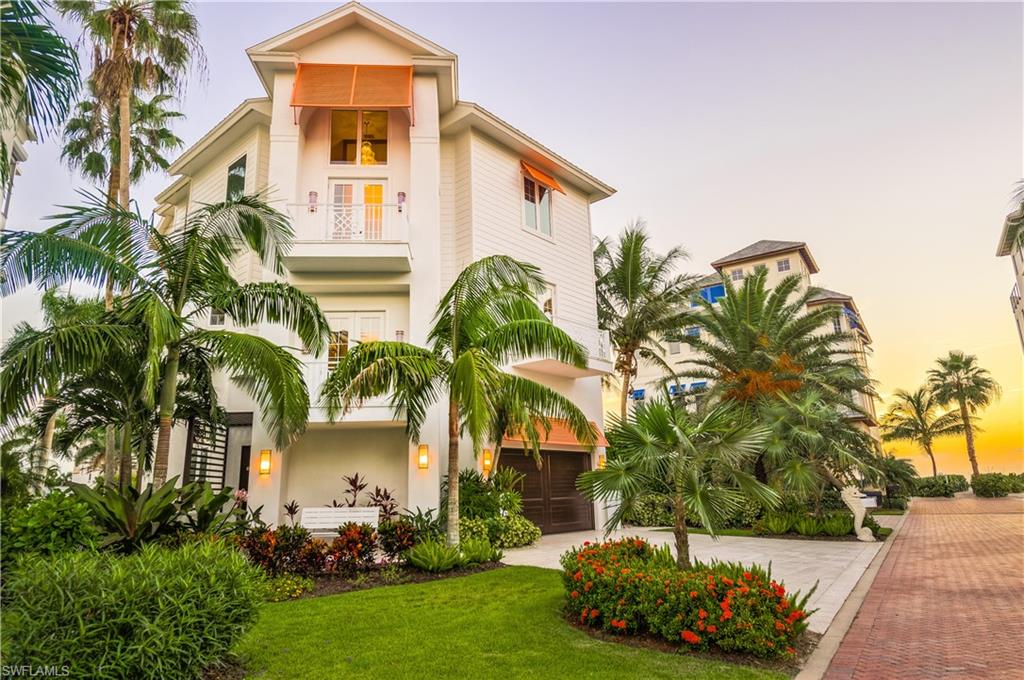 UNOBSTRUCTED VIEWS OF THE BAREFOOT BEACH AND THE GULF OF MEXICO! Recently renovated, multi-story, beachfront home has a coastal contemporary feel & is move-in ready.  Discover luxurious living w/a new modern kitchen w/granite counter-tops & custom marble backsplash, wood flooring, new architectural design by R.G. Design, brand-new paver driveway, new designer light fixtures, electric screens/storm shutters, elevator & more.  The open floor plan showcases volume ceilings & flows effortlessly from the indoor & outdoor spaces consisting of three, screened gulf front balconies offering breathtaking year-round sunsets. The master retreat features an office nook/den w/gulf views, private beachfront balcony & fully renovated spa-like bath w/dual white vanities, modern freestanding tub & oversized walk-in shower w/stunning seamless marble tile floors & shower walls. Residence is steps to the beach as well as the optional Barefoot Beach Clubhouse offering tennis courts two restaurants & beachside. Boat docks are available for purchase. Ideally located just minutes to Mercato & Waterside Shops and a short drive to downtown Naples world-class shopping, fine dining & entertainment.