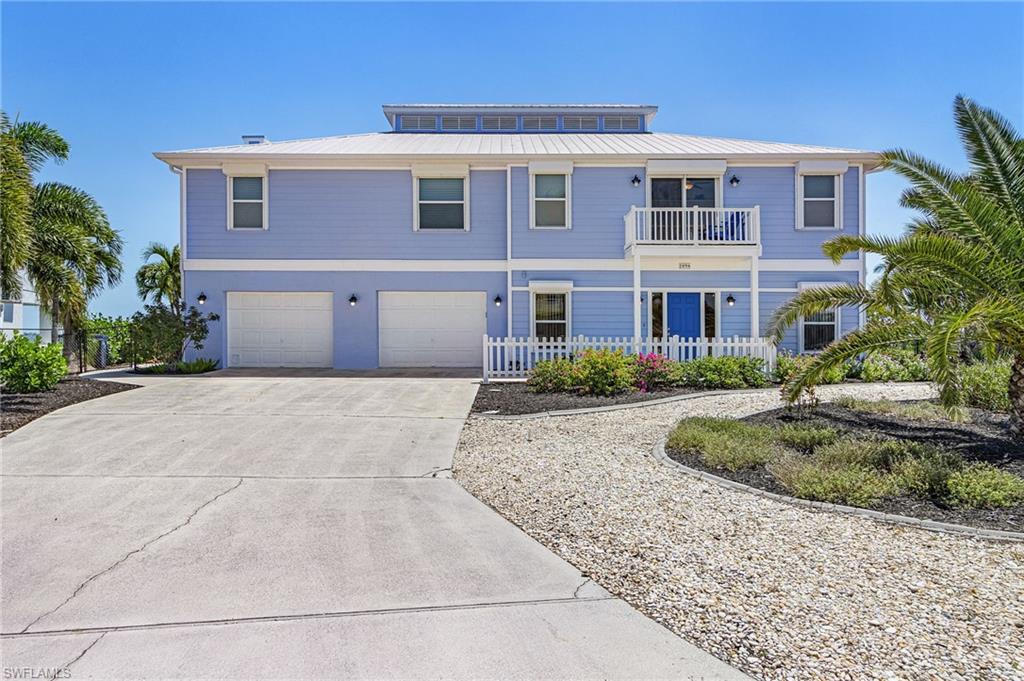 Welcome to a rare direct Gulf access waterfront estate in the highly sought-after Pine Island Shores community. Perfectly positioned to capture expansive bay views and abundant marine wildlife, this property offers a front-row seat to dolphins playing, manatees gliding by, and unforgettable Southwest Florida sunsets—all from your own backyard. With no bridges to open water, you’ll enjoy effortless access to Pine Island Sound and the Gulf of Mexico.  This spacious 2-story coastal retreat features 3 bedrooms + den and 3 bathrooms, designed with a bright open floor plan, cathedral ceilings, and large windows that showcase the stunning waterfront setting throughout the home.  The outdoor living experience is truly exceptional. Relax or entertain around your private saltwater pool and spa, expansive patio, gazebo, and multiple balconies are all perfectly oriented to take in the sweeping bay views and coastal breezes. Boating enthusiasts will appreciate the private dock with lift, water, and electric, making it easy to spend your days on the water.  Inside, the home offers a well-appointed kitchen with ample cabinetry and eat-in space, a generous primary suite with dual sinks and separate tub and shower, and flexible living areas including a den/home office. Additional highlights include a metal roof, electric storm shutters, fireplace, surround sound wiring, and abundant storage throughout.  Located in a gated boating community, this property combines privacy, space, and a true connection to the water.  Whether you’re looking for a full-time residence, seasonal retreat, or luxury waterfront escape—this is Pine Island living at its finest.
