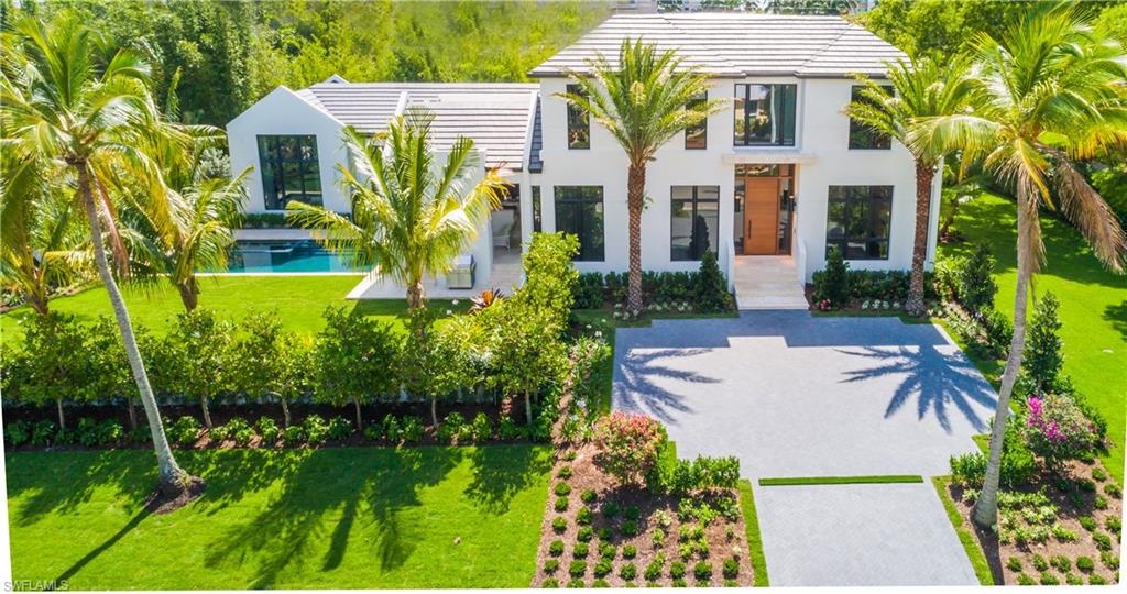 This "deconstructed classic American house", designed by Falconer Jones and Jeffrey Fisher Homes and built by BBA Development is now complete.  Located just one block from the Gulf of Mexico and minutes to Third Street and Fifth Avenue South.  The interior dimension is 5,000 sq. ft. under air with 6,500 sq ft under roof.  The home contains 5 bedrooms plus a study and six and on half baths.  The house also has a four car garage.  The interior includes hardwood floors throughout, Miele appliances, a butlers kitchen, LED lighting, architectural staircase, floor to ceiling glass and custom wood work throughout.  The exterior includes coral stone decking, summer kitchen, electric roll down screens and shutters and an outdoor fireplace with a custom mahogany wall feature. Construction of the home is concrete block on both the first and second floor including a floating concrete staircase.  The home has a complete home automation system designed by Elan G.