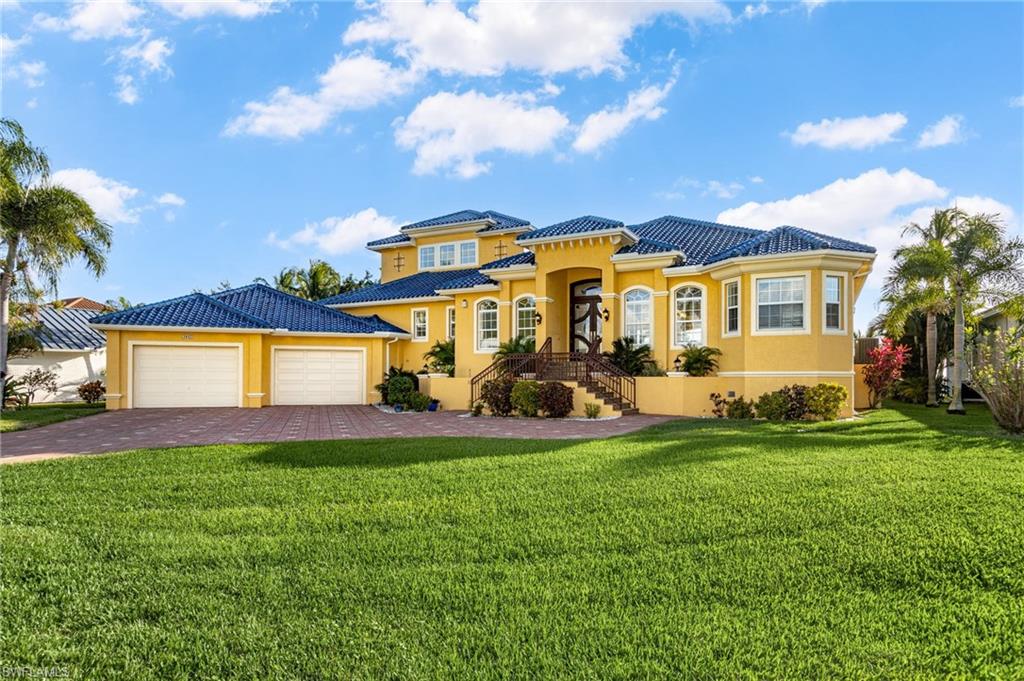 One of a kind Opportunity to own this incredible Riverfront Estates on one of Cape Coral's most popular streets: "Dolphin Dr".  3 Minute walk to the Cape Coral Beach, Yacht Club and Boat House.  This home is situated on a triple lot site with approx. 126 feet of prime Cape Coral River frontage.  The raised granite staircase leads up to the custom glass double door entry, opening up to the great room and onto the River.  This custom designed home has a beautiful European inspired kitchen with enameled cupboards and drawers, Bosch appliances, and large pantry closet. There are three large bedrooms all of which have their own bath, two have direct access to the lanai and pool. The second floor is reserved for the master suite; a large bedroom with sitting area, walk out balcony overlooking the River and Lanai, and his and hers walk in closets. The master bath features double vanities, separate soaking tub and walk in shower.   The Best for last, an 1800 foot tiled garage with space for seven vehicles and a small workshop are every car enthusiasts dream.