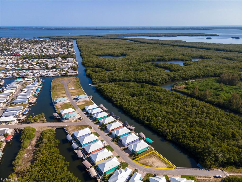 ONLY lot available in Treasure Cove that is not owned by the developer. Buy now and build later or get started today. Looking for a home? We'll connect you with the community builder or recommend another great local builder. This oversized lot is situated on the West Side of Treasure Cove and Overlooks Mangroves for a view that will NEVER be replaced by something man-made. Because of its large size, you could build a Bigger House, ADD A POOL, Larger Garage, the possibilities are endless. This development offers sewer which allows you to fit a much larger home than other areas of St James City and NO septic to maintain. With 100 ft of seawall you can place your lift to the side and enjoy the beautiful water views. Cleared and ready to get you on "Island Time".