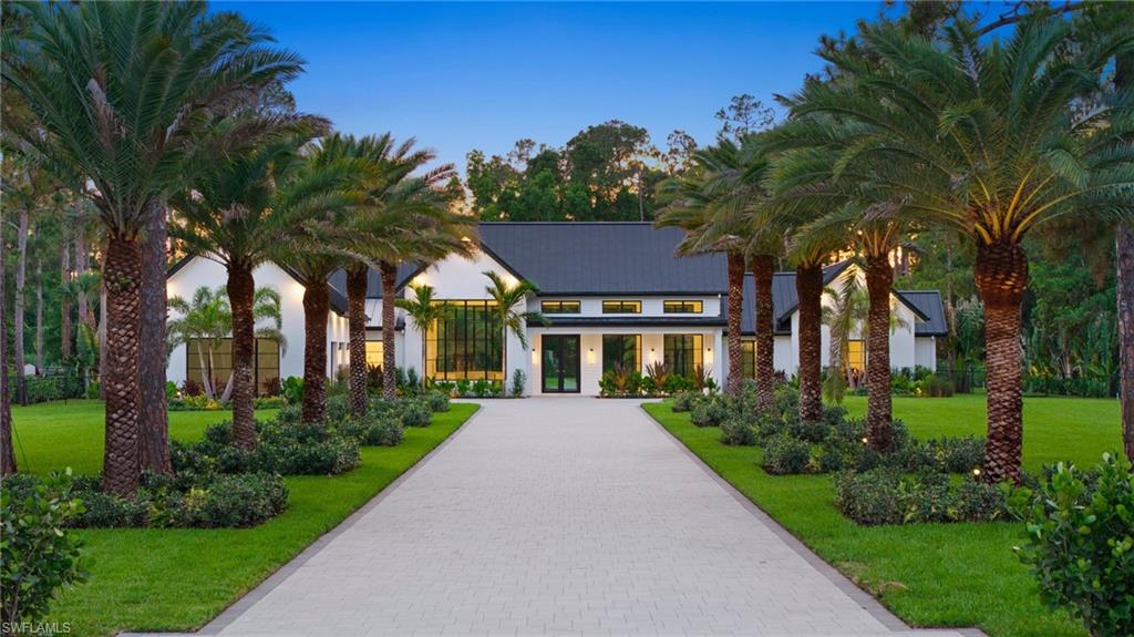 One or more photo(s) has been virtually staged, AI generated or rendered.  Built by Knauf Koenig Group, one of Naples' most respected luxury builders, this exceptional new construction estate offers uncompromising quality, craftsmanship, and design on 2.73 fully cleared, elevated, and fenced acres. Encompassing 4,000 square feet under air, this thoughtfully designed single-story residence seamlessly blends modern luxury with comfortable everyday living. The open-concept floor plan showcases architectural beam details throughout, concealed A/C vents for a clean and sophisticated aesthetic, and abundant natural light. At the heart of the home is a stunning gourmet kitchen featuring premium Fisher & Paykel appliances, dual sinks, dual dishwashers, exquisite Taj Mahal quartzite countertops, and custom Ruffino cabinetry. The residence offers four spacious ensuite bedrooms, four full bathrooms, and two half baths, plus a private office that can easily serve as a fifth bedroom or guest suite. Built with efficiency and longevity in mind, the home features spray foam insulation, ES impact windows with Low-E coating, a metal roof, and a brand-new well. Designed to embrace the Florida lifestyle, the outdoor living space is truly exceptional. A resort-style pool and spa are complemented by a fully equipped outdoor kitchen, creating the perfect setting for entertaining family and friends year-round. The extensive custom landscape package includes a fully fenced property bordered by mature Clusia hedges for privacy, a palm-lined driveway, additional palms surrounding the pool area, and professional landscape lighting that beautifully showcases the grounds after sunset. Additional highlights include a spacious three-car garage, premium finishes throughout, and nearly three acres of beautifully improved land. A rare opportunity to own a signature Knauf Koenig Group estate that combines luxury, privacy, and exceptional craftsmanship. Ideally located in one of Naples' most desirable areas, this property offers the perfect balance of privacy and convenience, just minutes from Founders Square, some of Naples' finest golf courses, upscale dining, shopping, and everything that makes the Naples lifestyle so sought after.