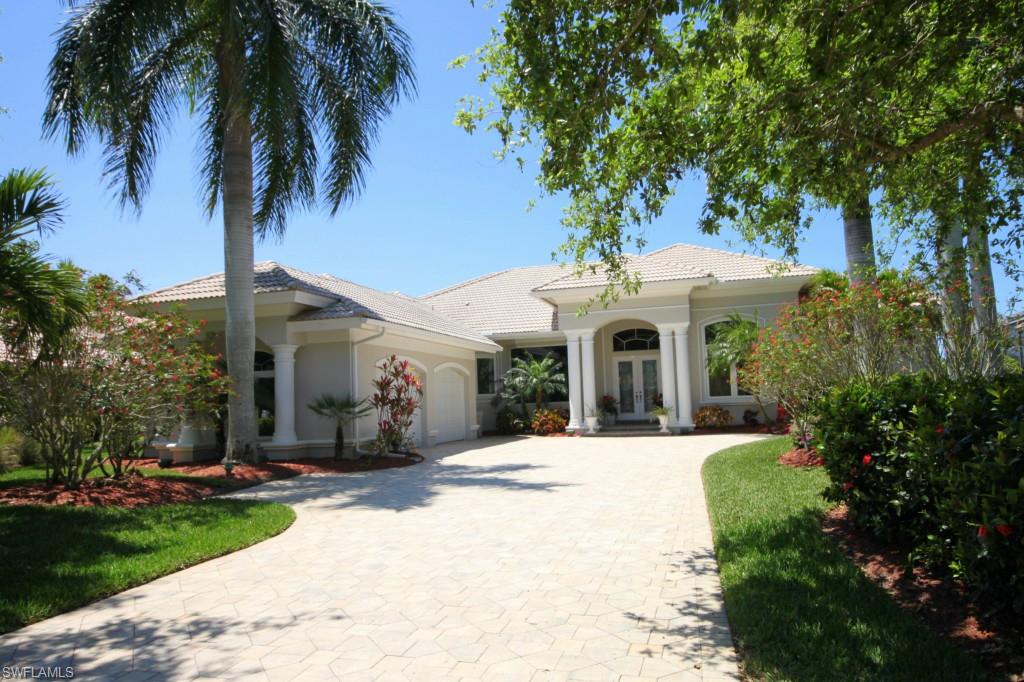 Immaculate, 3+den, 4 full, ½ bath home boast numerous upgrades throughout.  Beautifully decorated with large tile throughout, carpet in bedrooms, crown molding, custom built-ins, and professional window treatments.  Home boasts 2 HVAC units, plus unit in the garage with epoxy floor finish, high impact windows, sound system,  re-built lanai enclosure, cyber rain irrigation system, are just a few.  Formal dining room and living room with sliders to the lanai for extended living area with beautiful travertine flooring.  Entertain in the gourmet kitchen, with built-in paneled appliances, cabinetry with crown, granite countertops open to the family room with corner-corner pocket sliders bringing the outdoors in.  For family and guests, bedrooms with private baths and one bedroom offers entry to private lanai area.  Master suite boasts, walk-in closet, private bath and French door access to lanai with beautiful views of the lake and woods for privacy.  Gather around the outdoor kitchen bar with your guests, enjoying the ambiance of the exterior and island bed landscape lighting on automatic settings, built-in pool/spa with new heater and soothing SW views of a lake and preserve beyond.