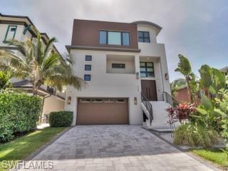 This is it! This is that once in a lifetime real estate opportunity. Nearly new Elegant Island home located on the “50 yard line” of Fort Myers Beach. This gem sits directly across from the future lobby entrance of the soon to open Margaritaville Resort. A half block to the famous sandy beach, Times Square, and the North End Bridge-making access to and from this home a snap. Stunning great room with fully upgraded chef’s kitchen including gas range and ice maker and oversized refrigerator, spectacular full waterfall center island perfect for gathering and entertaining. Upper level features three oversized bedrooms all with ensuite bathrooms. The master suite has soaring vaults and endless views from this island paradise. The backyard has a private outdoor shower stall and custom pool and spa. Three year old seawall, dock and 10,000lb boat lift. Most Pictures are pre-hurricane to showcase this homes sophistication and beauty. The upper two living levels fared extremely well through Hurricane Ian. The lower level performed as it was designed to. Owners have either completed the repairs or have materials on order and they will arrive as they are available
