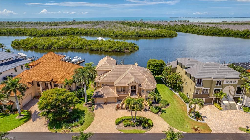 Exceptional Waterfront Luxury in Exclusive Jonathan Harbour!

Experience premier Southwest Florida waterfront living in the gated community of Jonathan Harbour on prestigious Connie Mack Island. Offering privacy, security, and direct Gulf access, this custom residence encompasses approximately 3,700 square feet of thoughtfully designed living space with panoramic water views throughout.

This elegant three-story home features four bedrooms, three full bathrooms, and three half baths, providing ample accommodations for family and guests. Meticulous attention to detail is evident throughout the residence.

The gourmet kitchen is equipped with premium appliances, custom cabinetry, generous workspace, and abundant storage. Perfect for entertaining, it easily accommodates multiple chefs while offering spectacular waterfront views. Soaring vaulted ceilings and expansive windows fill the adjoining great room with natural light, creating an open and inviting atmosphere.

A private elevator services all three levels. The ground floor offers extensive garage space for multiple vehicles, storage, and recreational equipment.

The second level features an elevated resort-style pool and spa, seamlessly blending indoor and outdoor living while providing a private setting to enjoy tranquil water views.

The versatile third-floor suite includes a full bath and kitchenette, making it ideal as a guest retreat, in-law suite, or home office.

For boating enthusiasts, the expansive private dock provides abundant space for watercraft and recreational equipment, while the 30,000-pound boat lift easily accommodates a large vessel.

The property's direct Gulf-access location offers quick access to the Gulf of Mexico and the renowned destinations of Sanibel Island and Captiva Island, along with beaches, waterfront dining, fishing, and island adventures that define the Southwest Florida lifestyle.